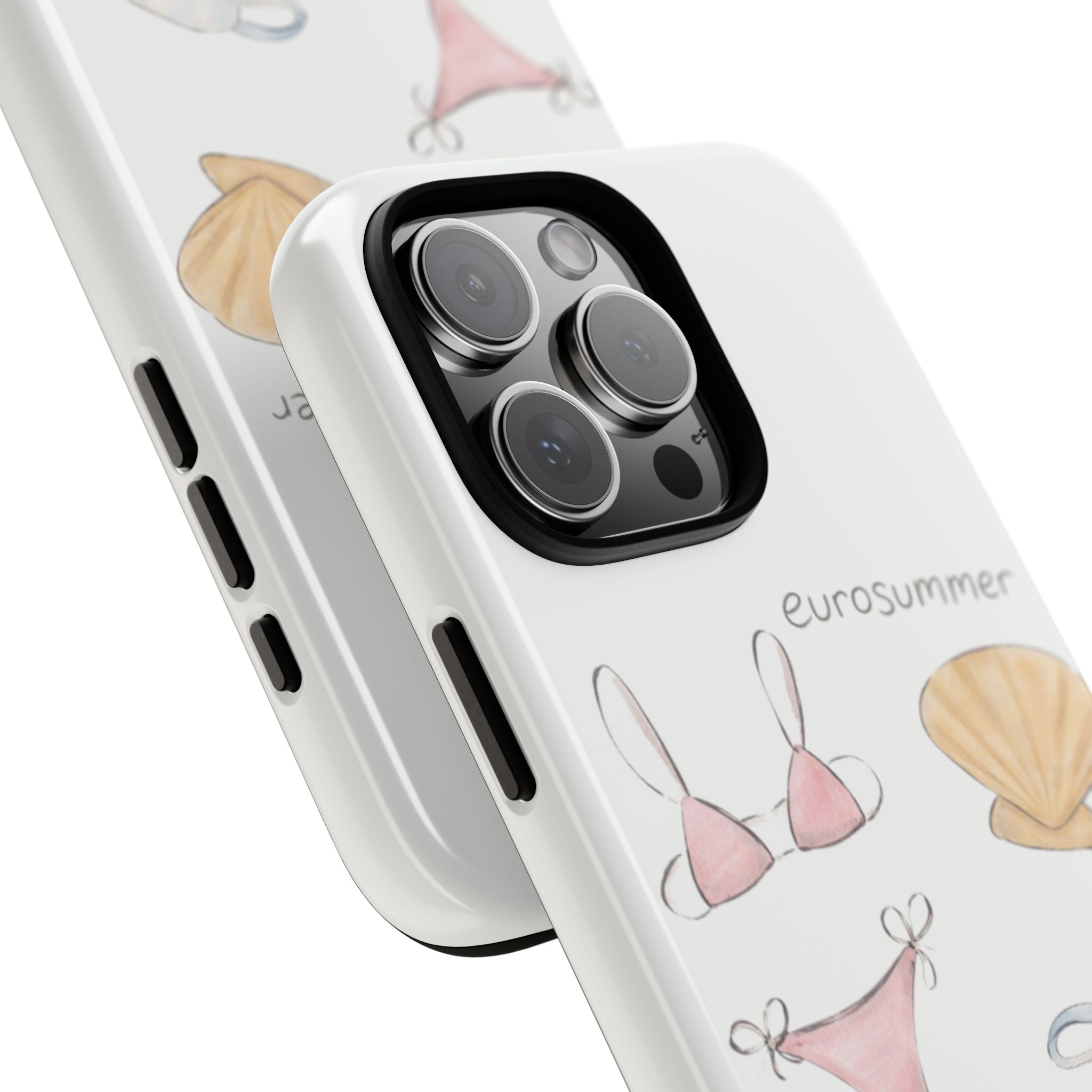 White phone case close-up with illustrated bikinis and seashell; camera lens cutout