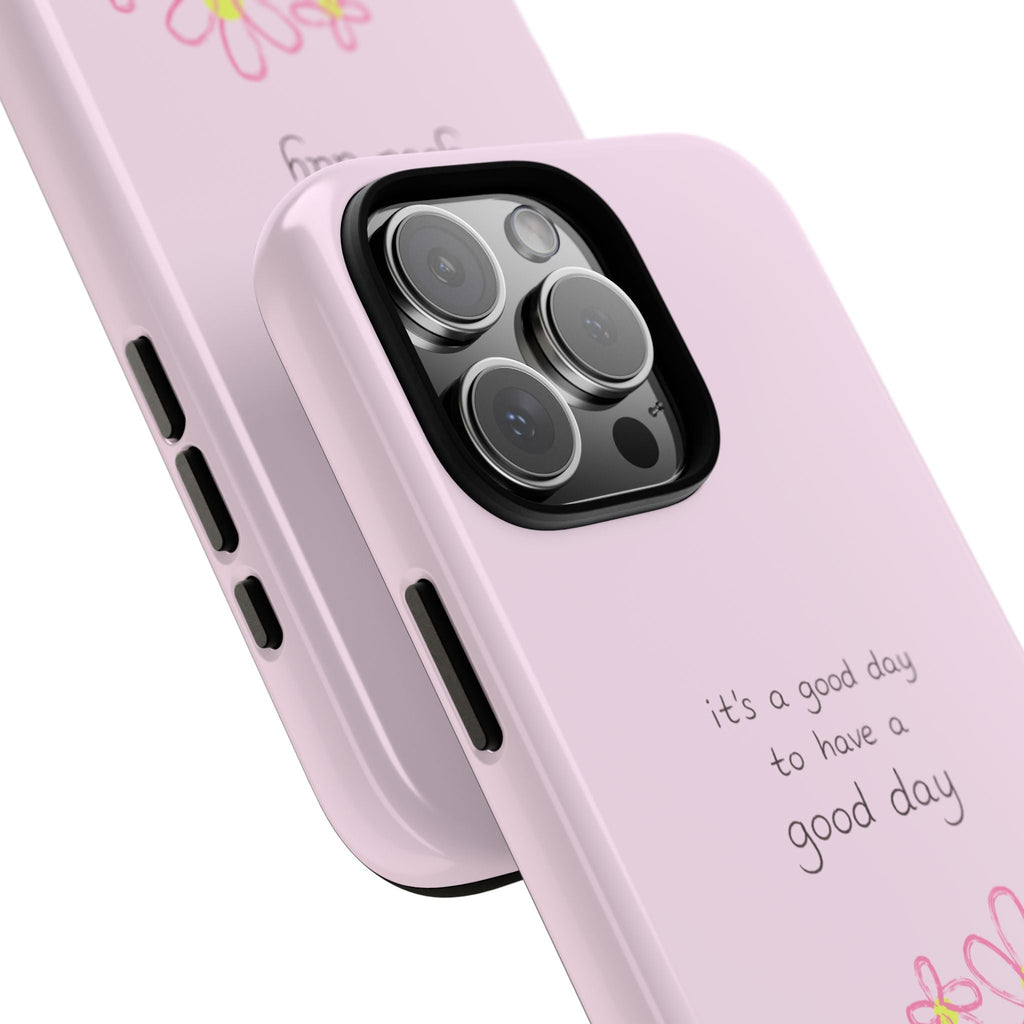 Pink phone case close-up: camera cutout, side buttons, and “good day” lettering
