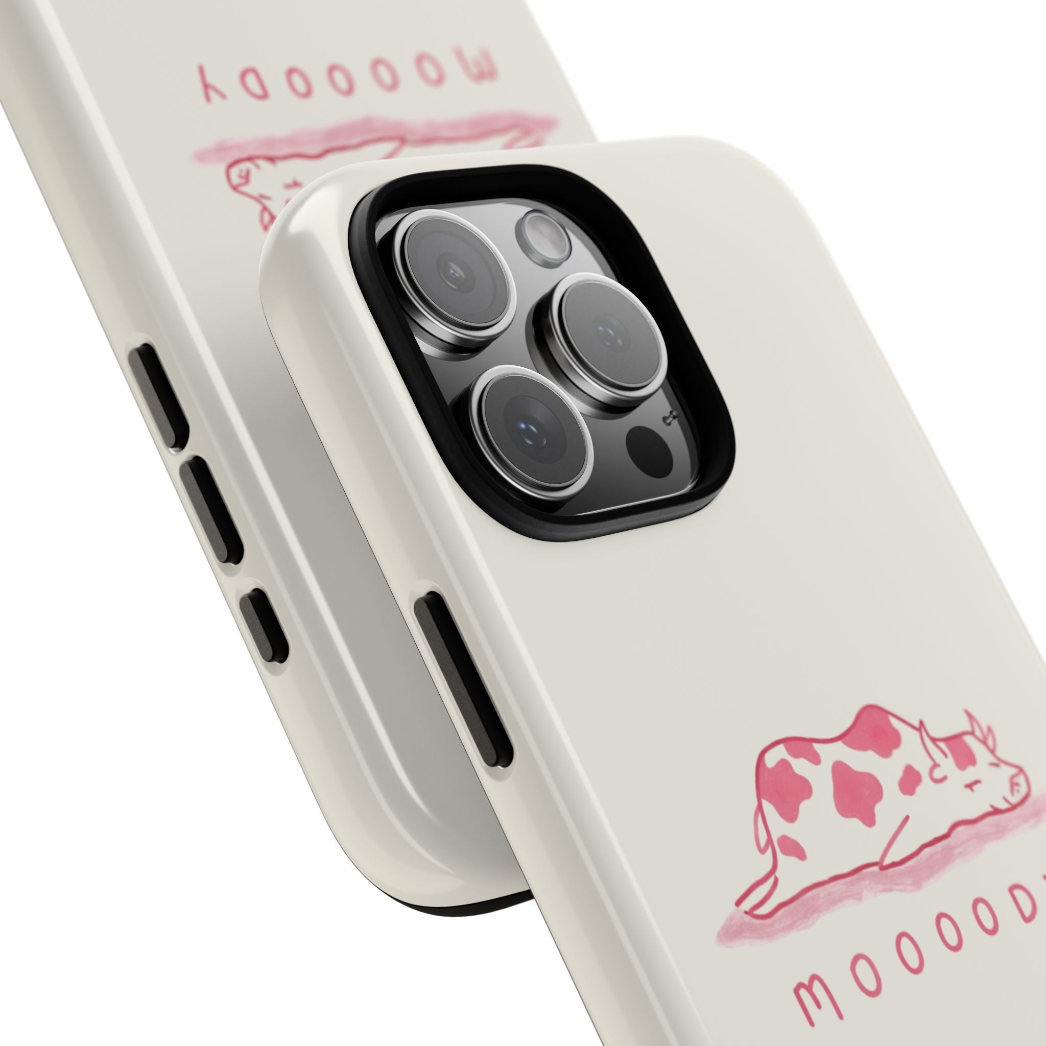 Close-up: cream phone case with pink cow 'moooody' print and camera lens opening