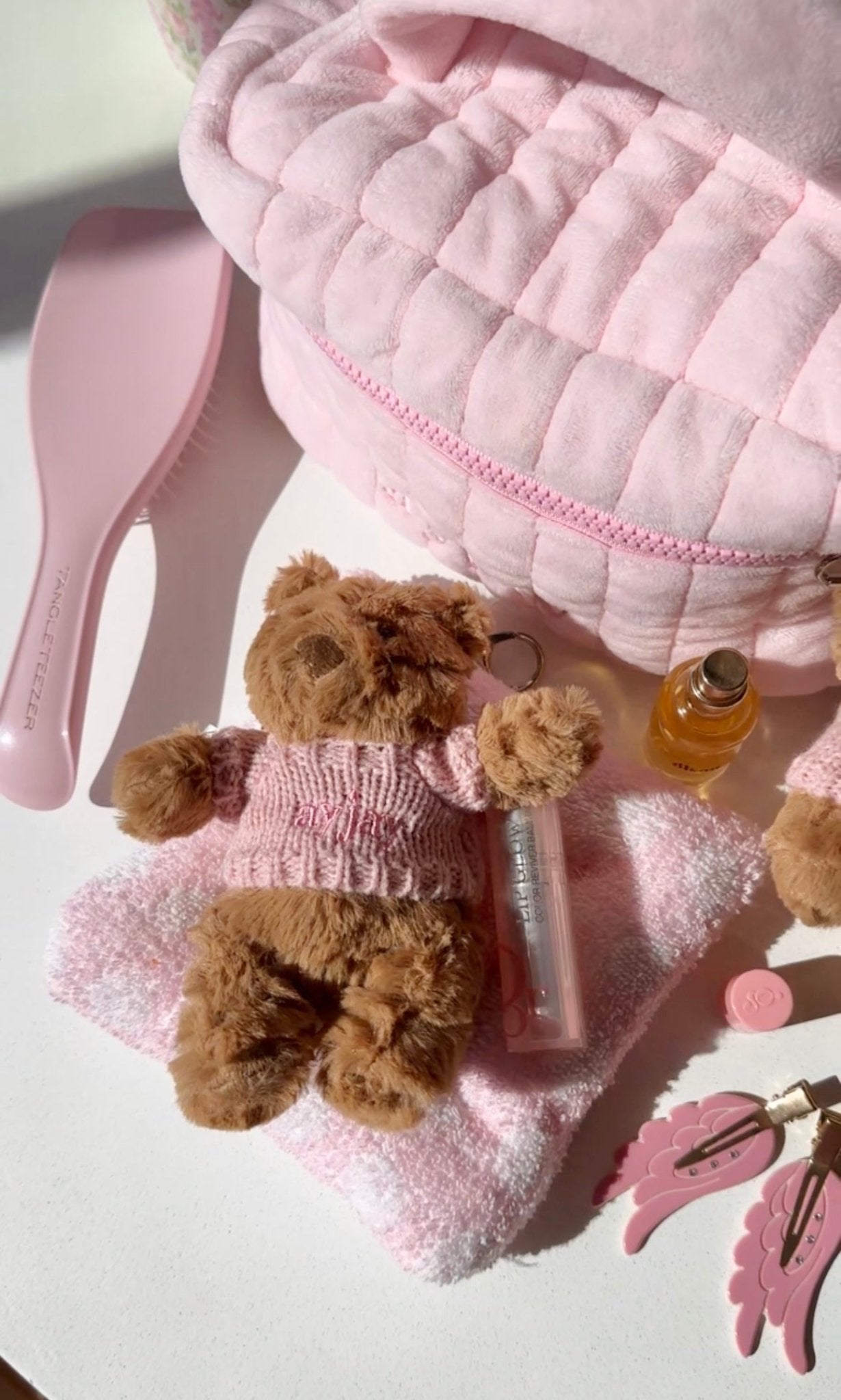 Close-up pink sweater teddy bear bag charm keychain with chain ring