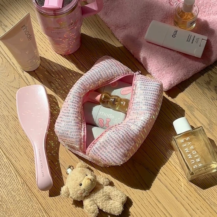 Pink sequin zipper pouch with teddy bear peeking out