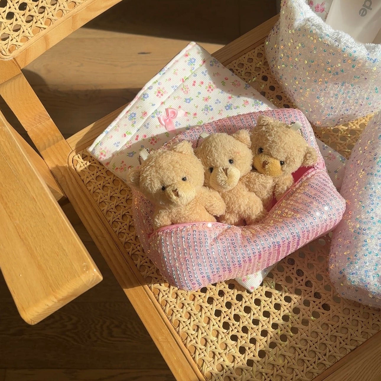 Pink sequin zipper pouch with three teddy bears inside