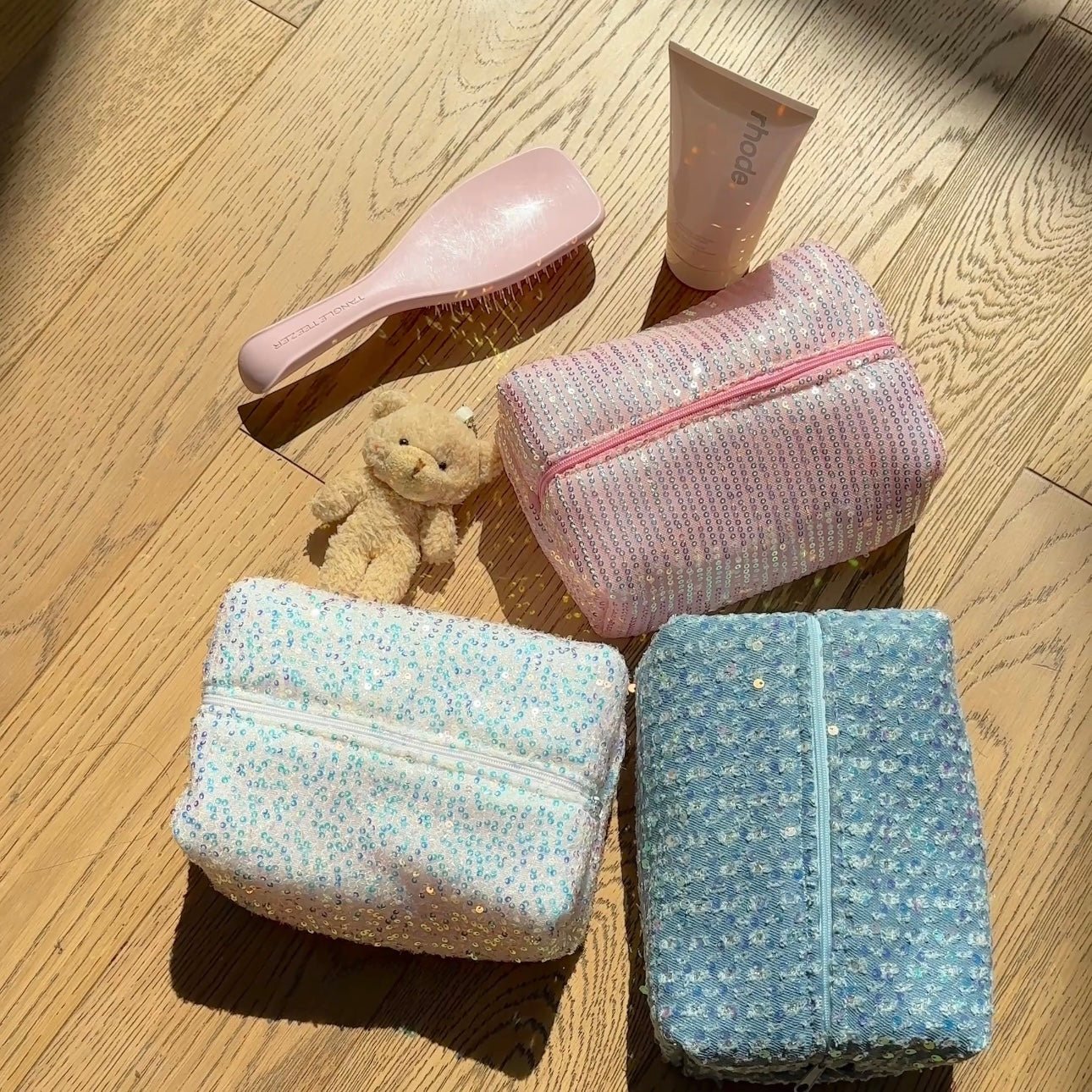 Silver sequin organizer pouches in light blue and blue with glittering zipper closures