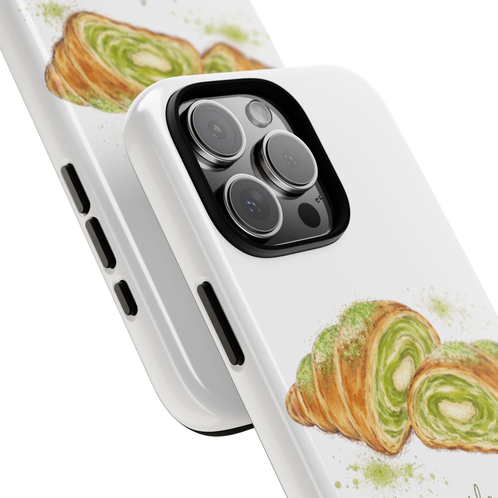 Angled white phone case with matcha croissant sketch and raised camera openings