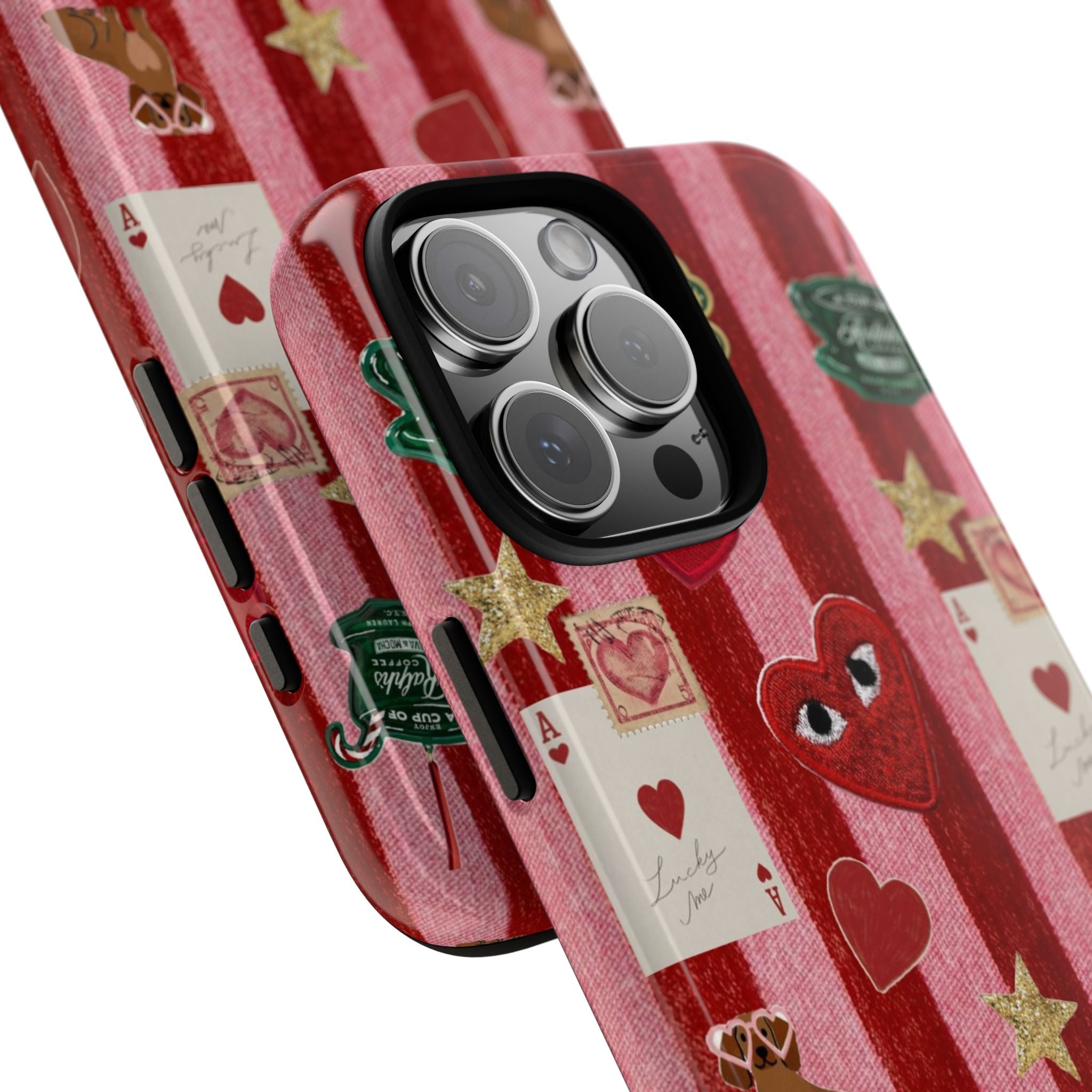Close-up pink velvet striped phone case with red heart graphic and playing cards; camera cutout