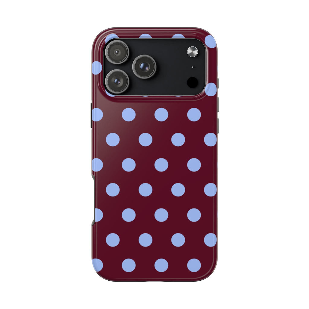 Maroon polka dot phone case with light blue dots, showing top camera area