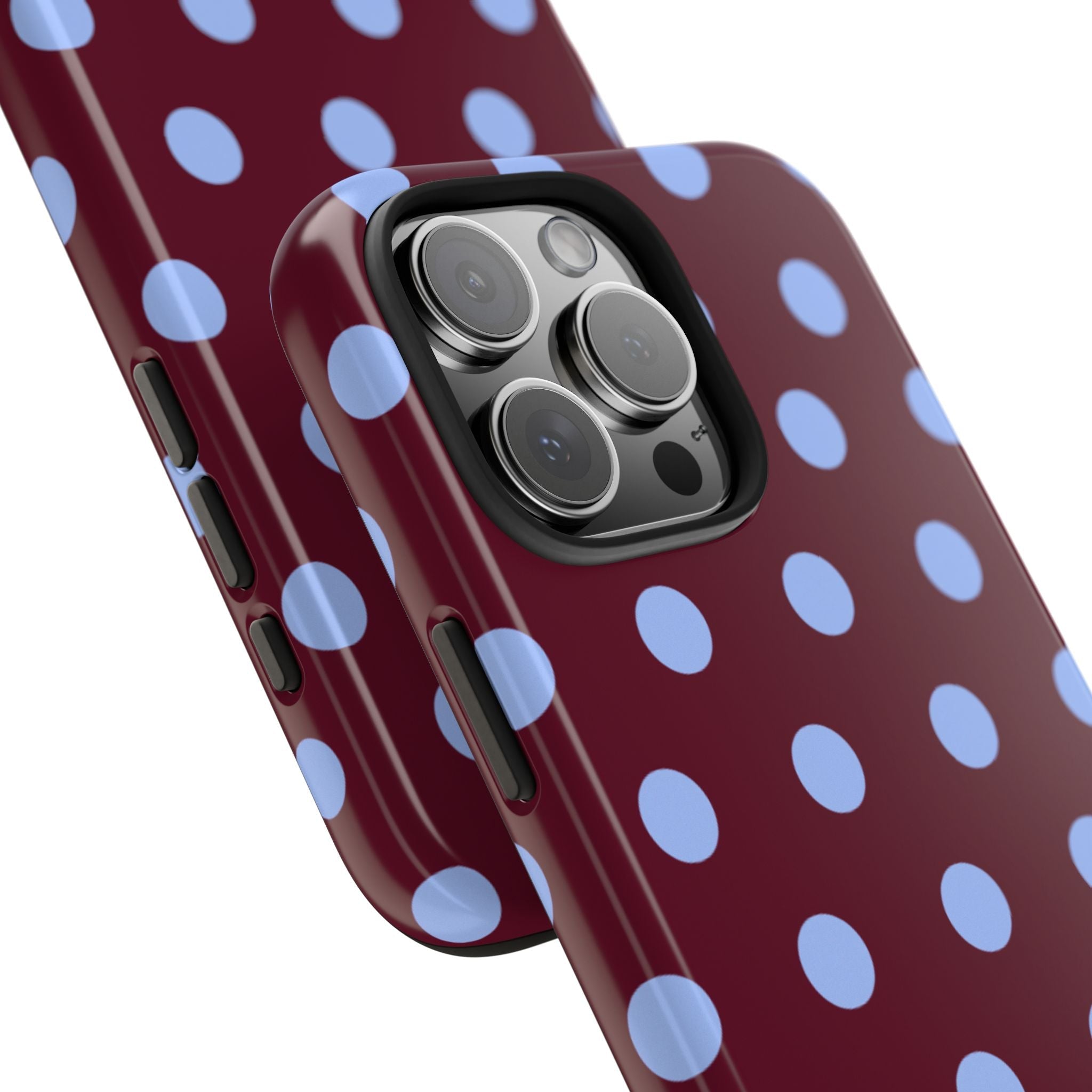 Close-up of maroon polka dot phone case with light blue dots near camera lenses