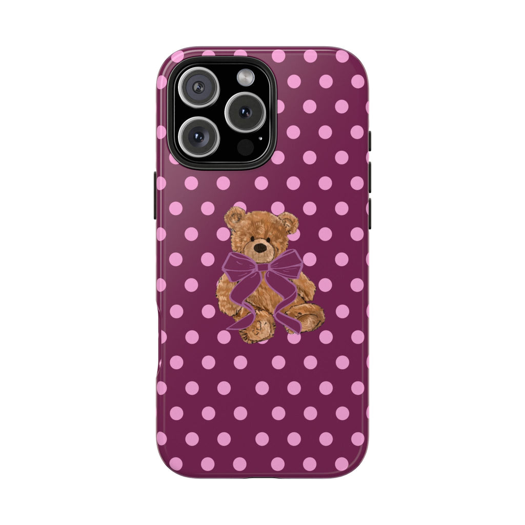 Magenta polka dot phone case featuring a teddy bear with a purple bow