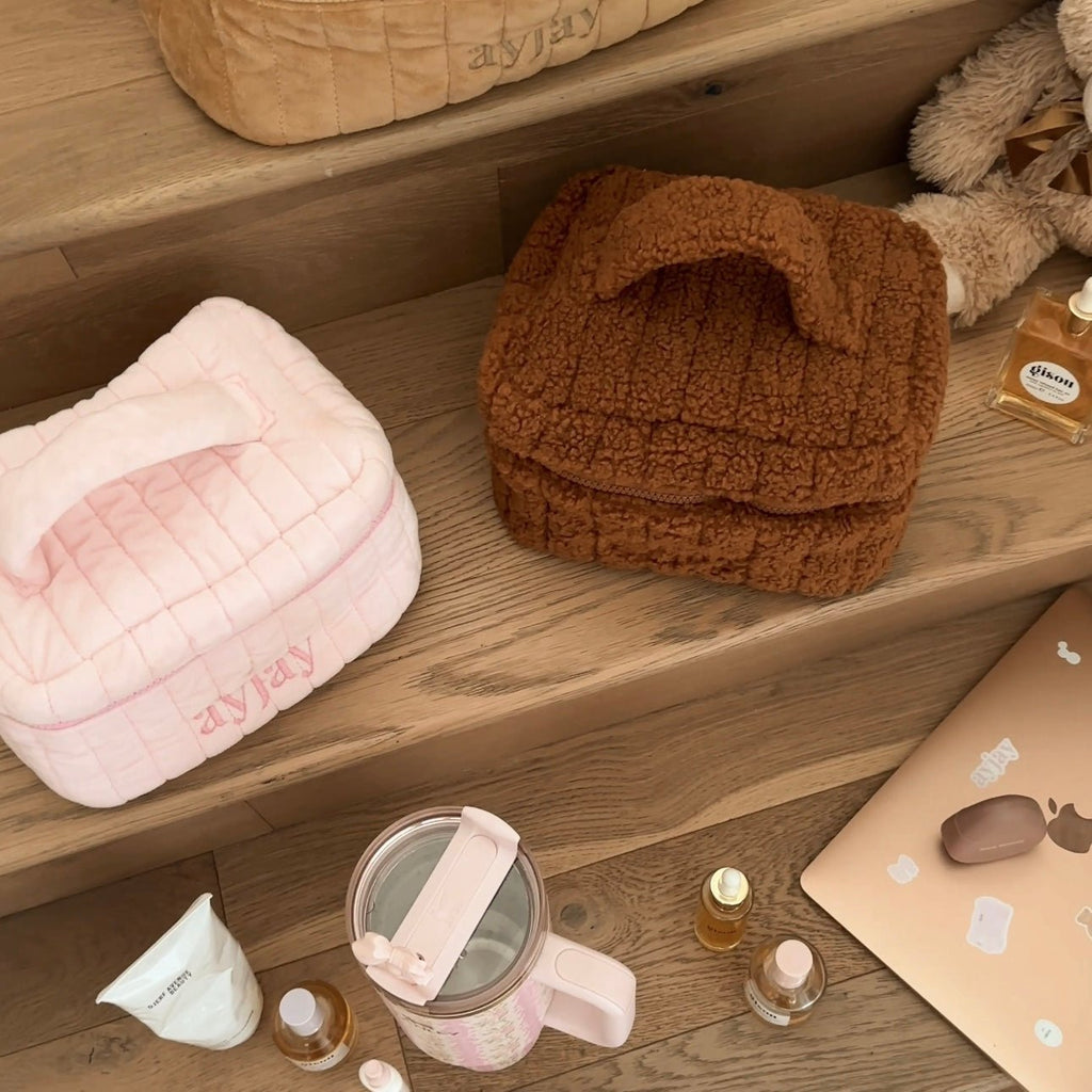 Closed brown teddy vanity bag with curved flap and top handle