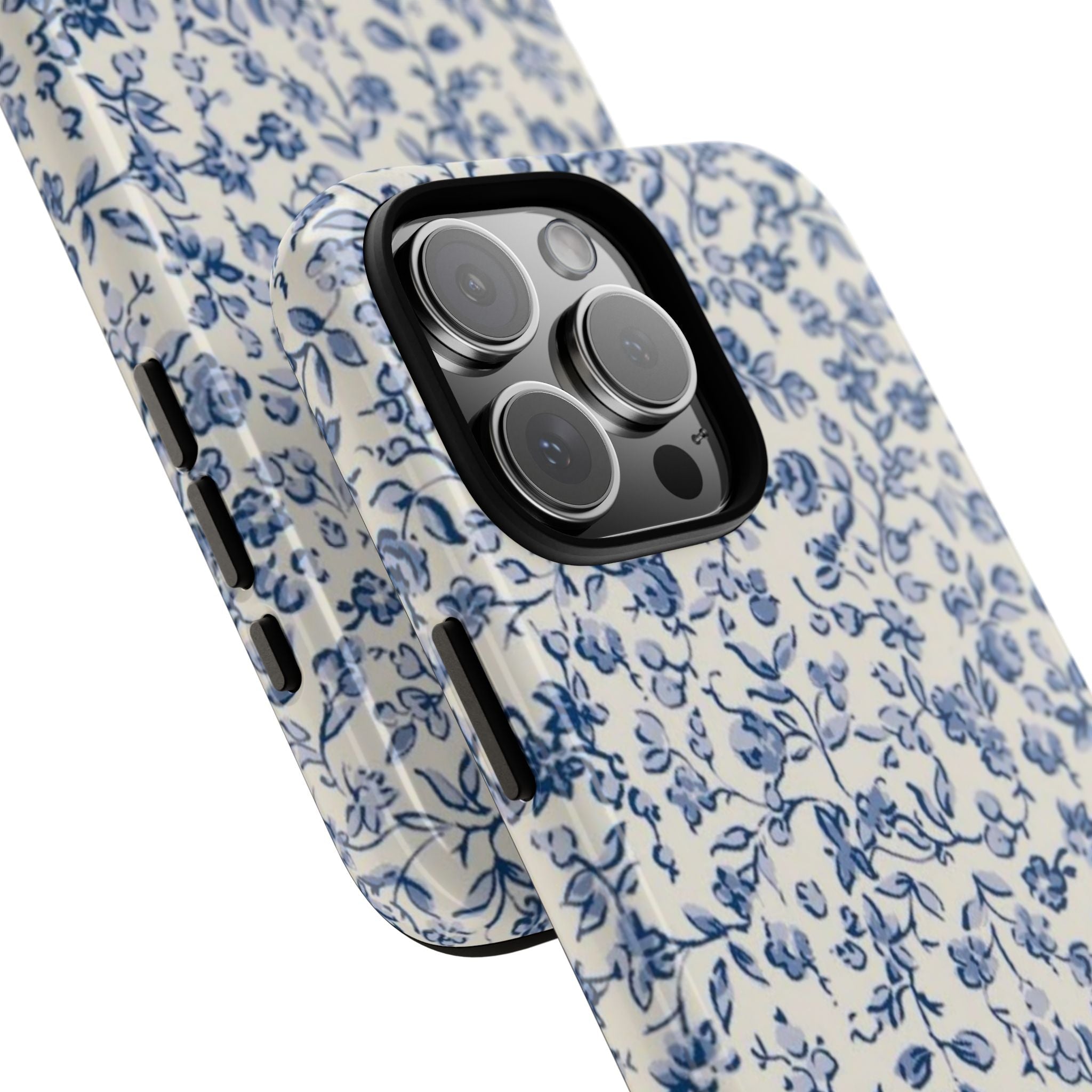 Phone case angled view with blue floral pattern and camera lenses with black trim