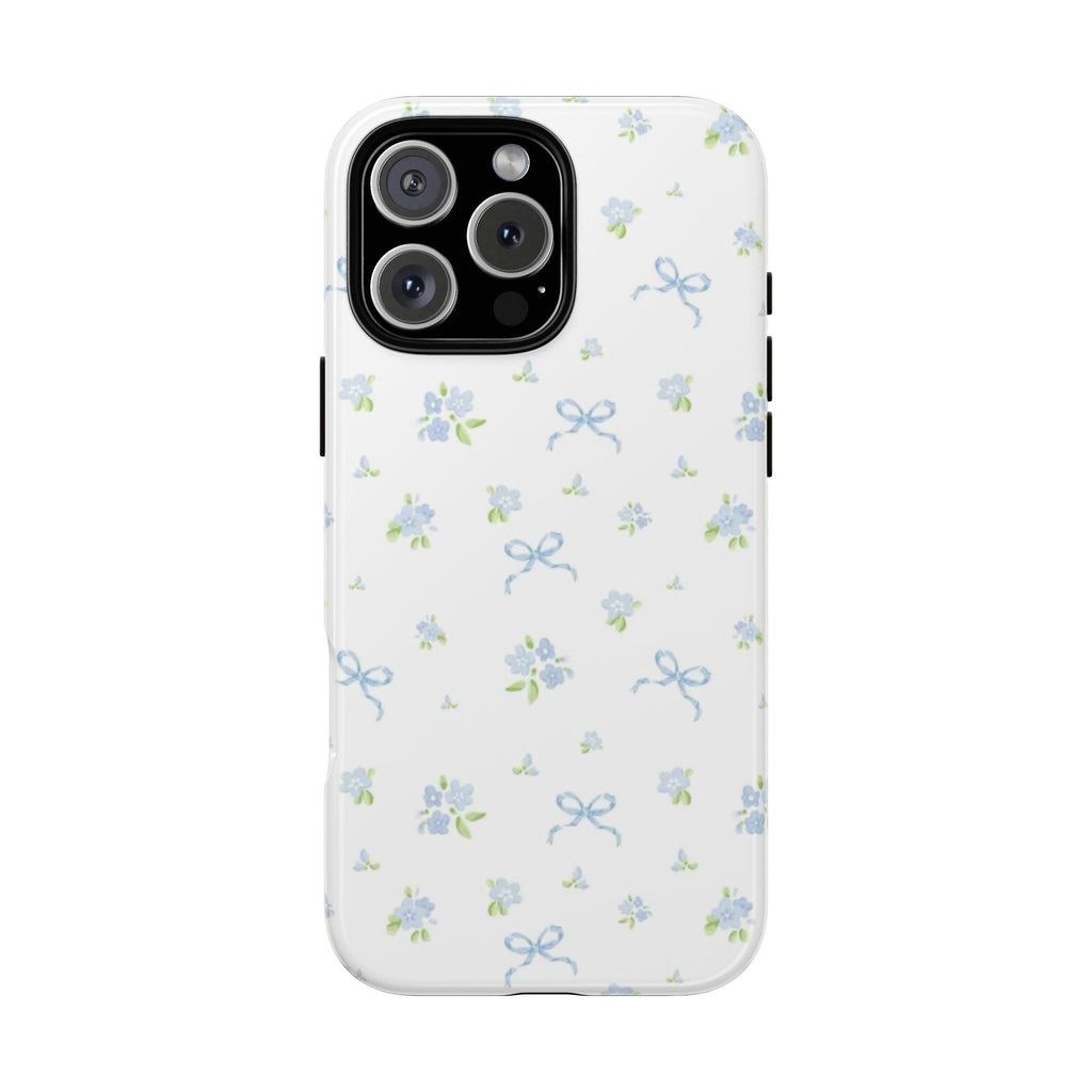 White phone case with blue floral pattern and small bow accents; camera cutout