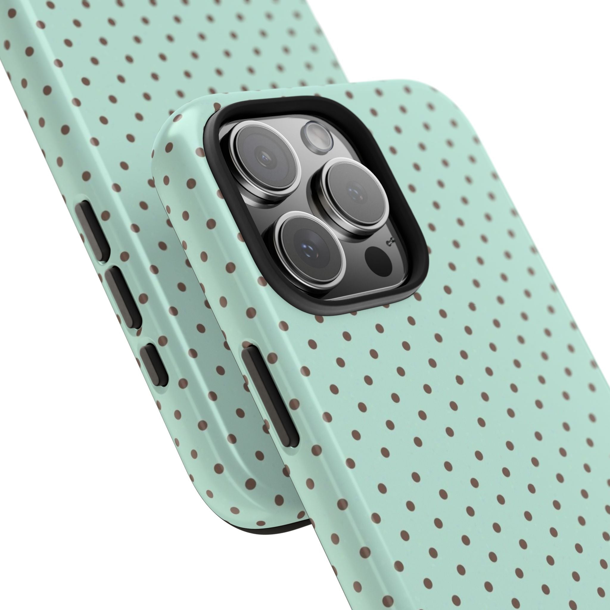 Mint green polka dot phone case in angled view; camera cutout and side button holes
