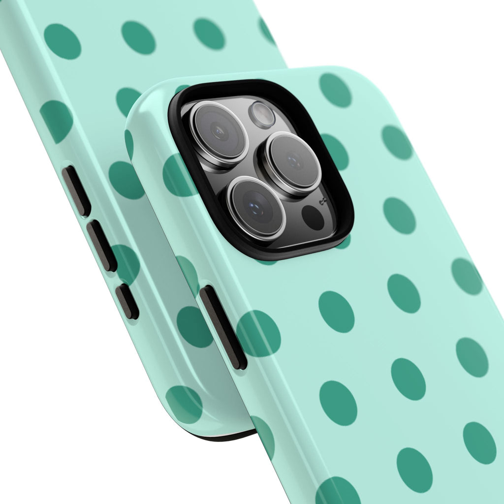 Close-up mint polka dot phone case with camera lenses and side button openings.