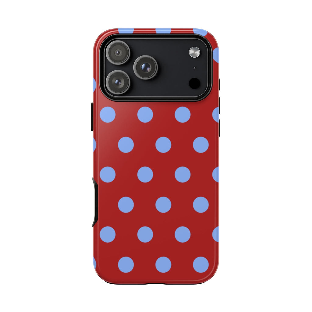Red phone case with blue polka dots, visible side button cutouts
