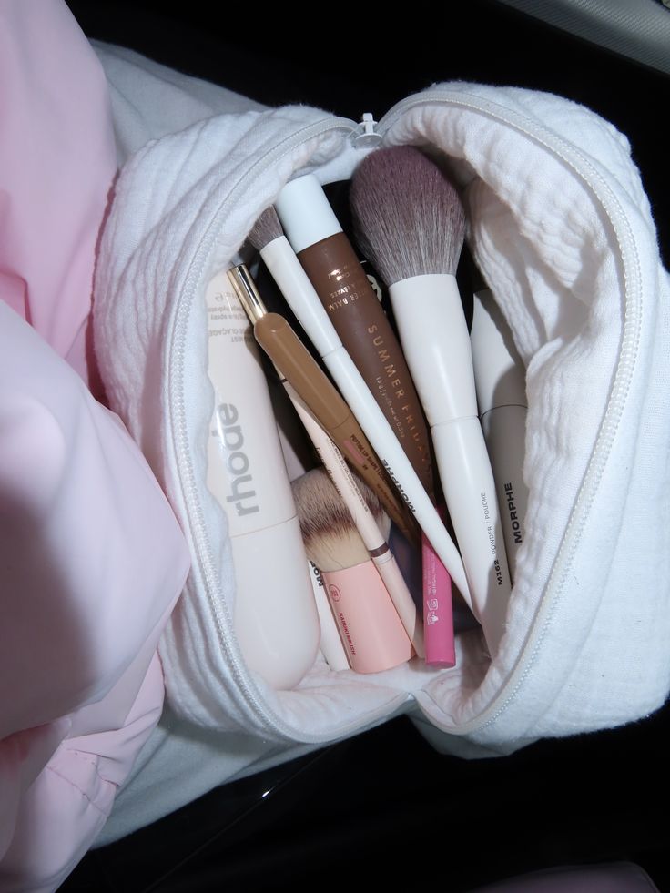 MOUSSELINE WHITE white zippered pouch with makeup brushes and beauty tools inside
