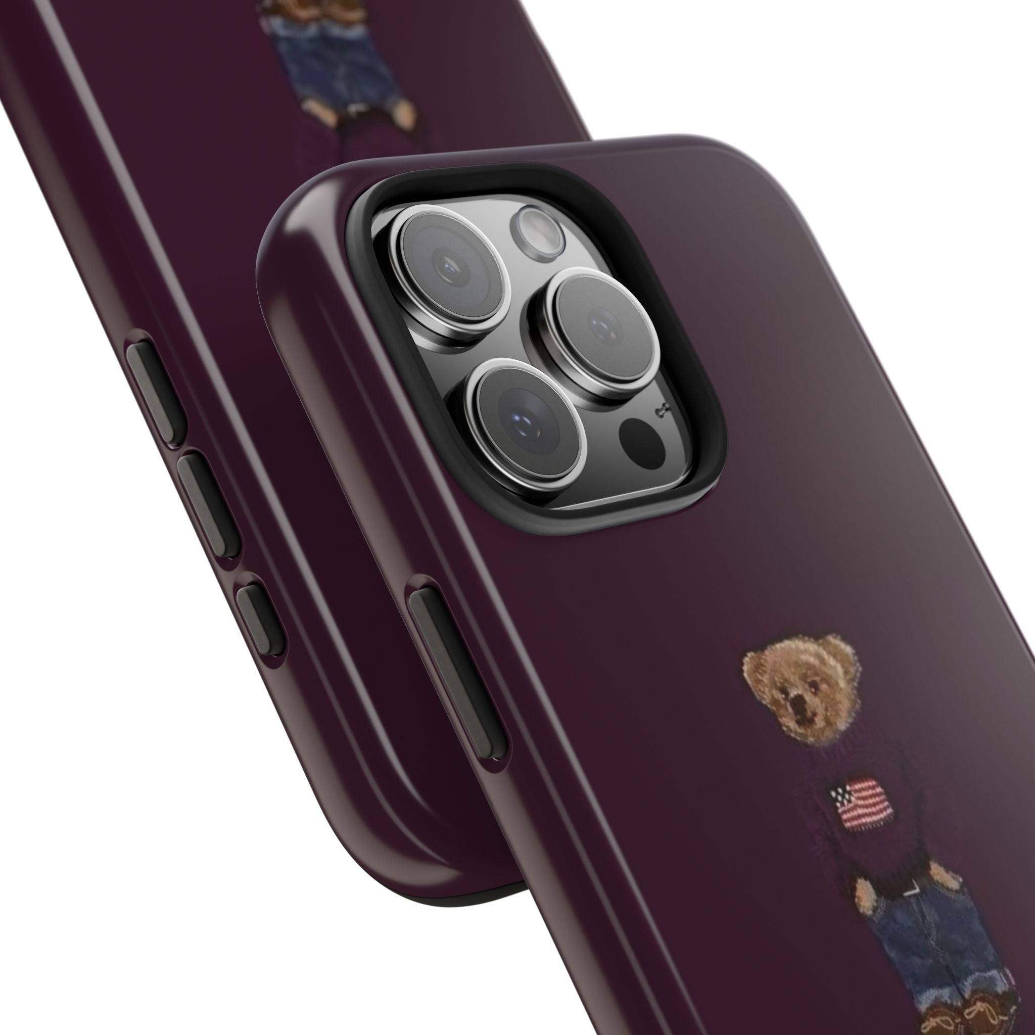 Close-up: burgundy phone case showing camera cutout and teddy bear badge