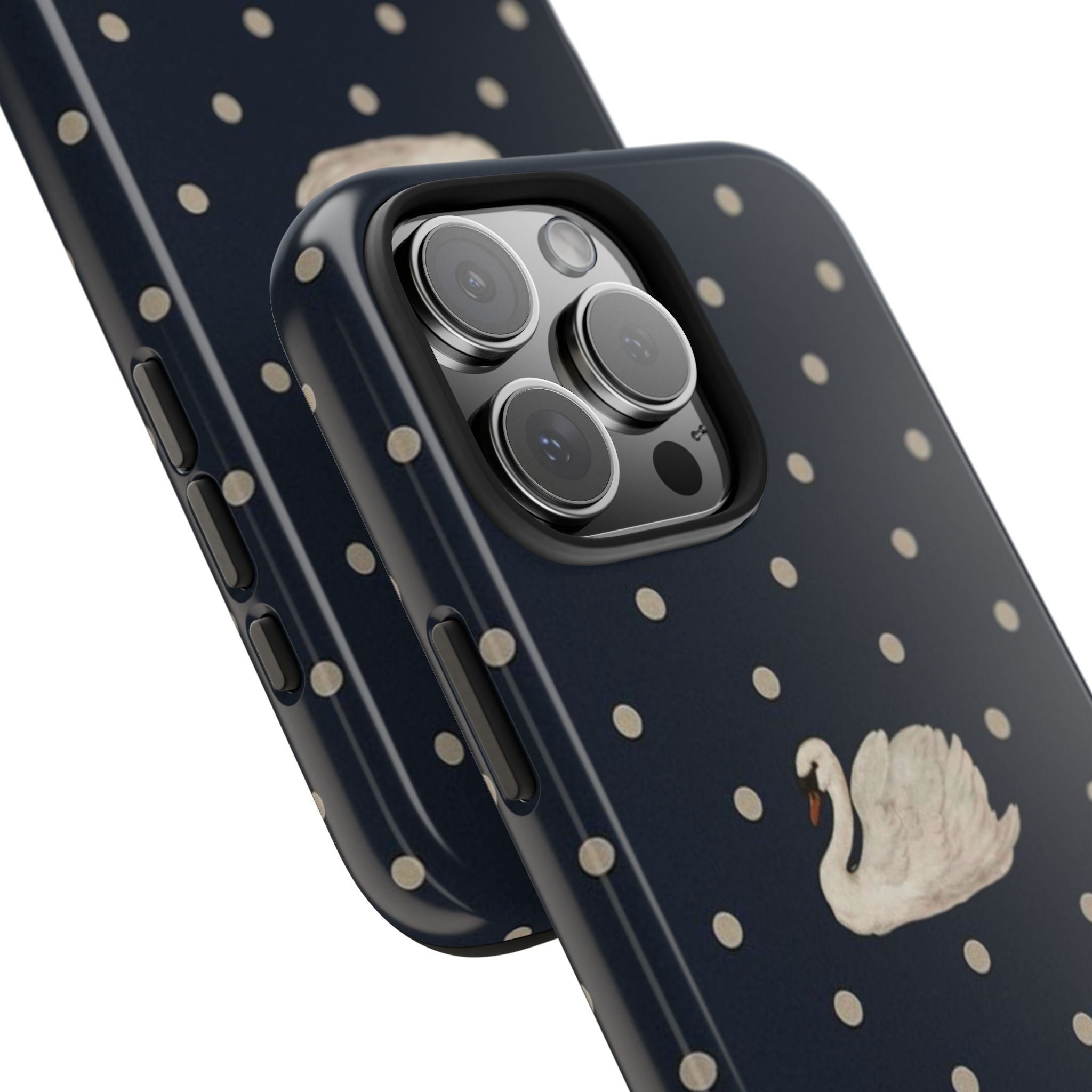 Navy blue polka dot phone case with cream swan near camera cutout