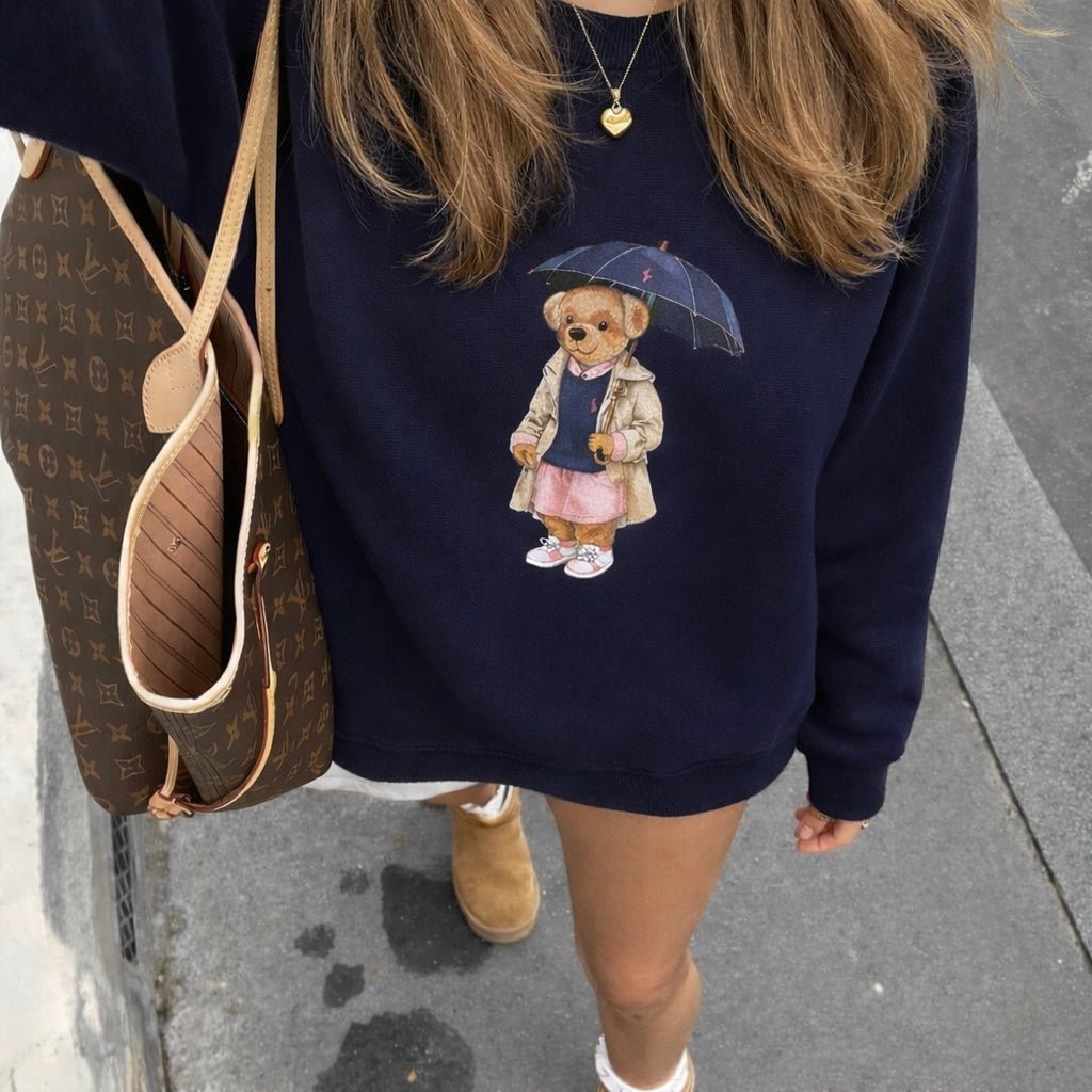 Navy blue teddy bear crewneck sweatshirt with small umbrella bear graphic