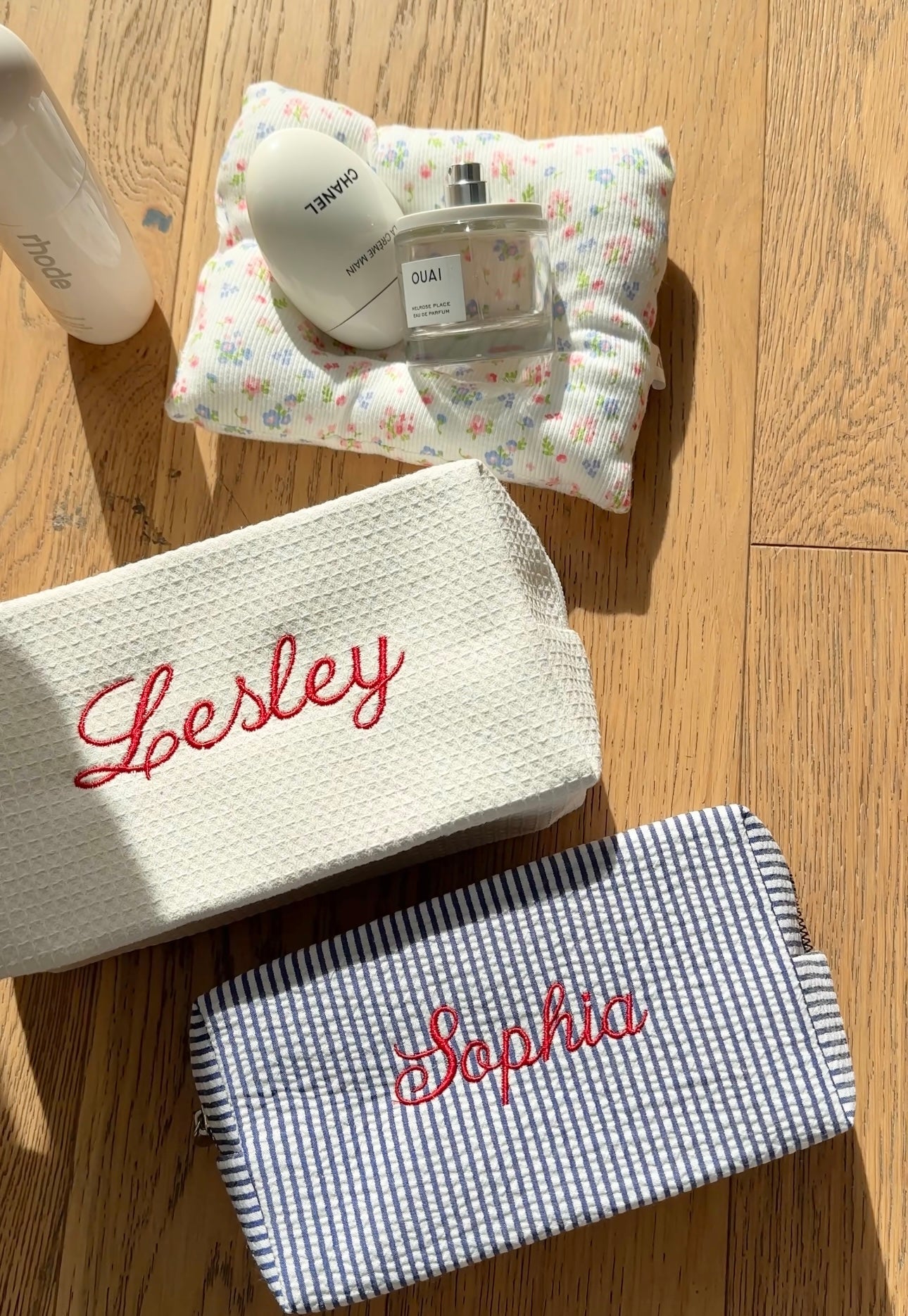 White waffle knit pouch with red cursive embroidery name, folded view