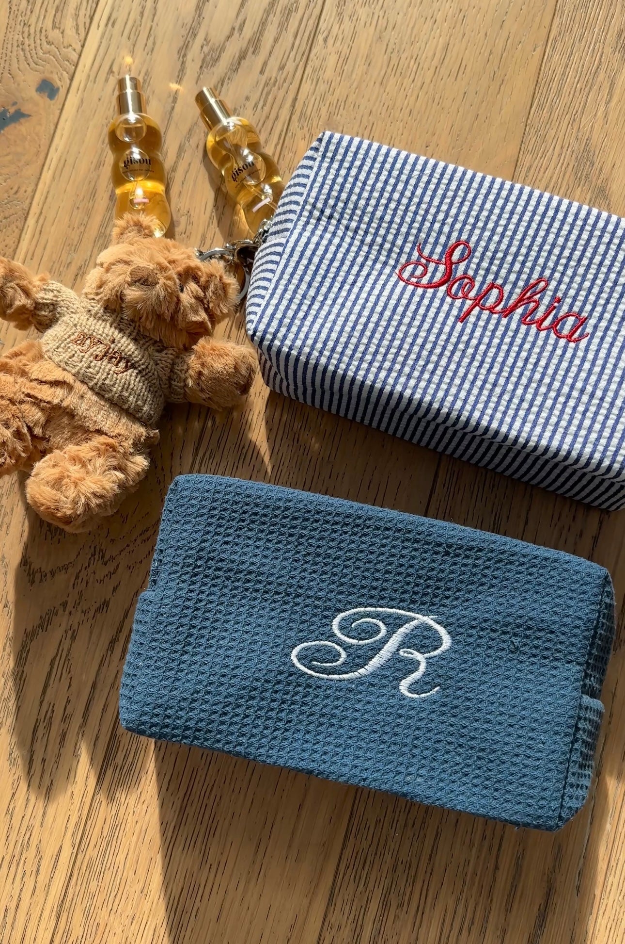 Blue zip pouch with white embroidered monogram