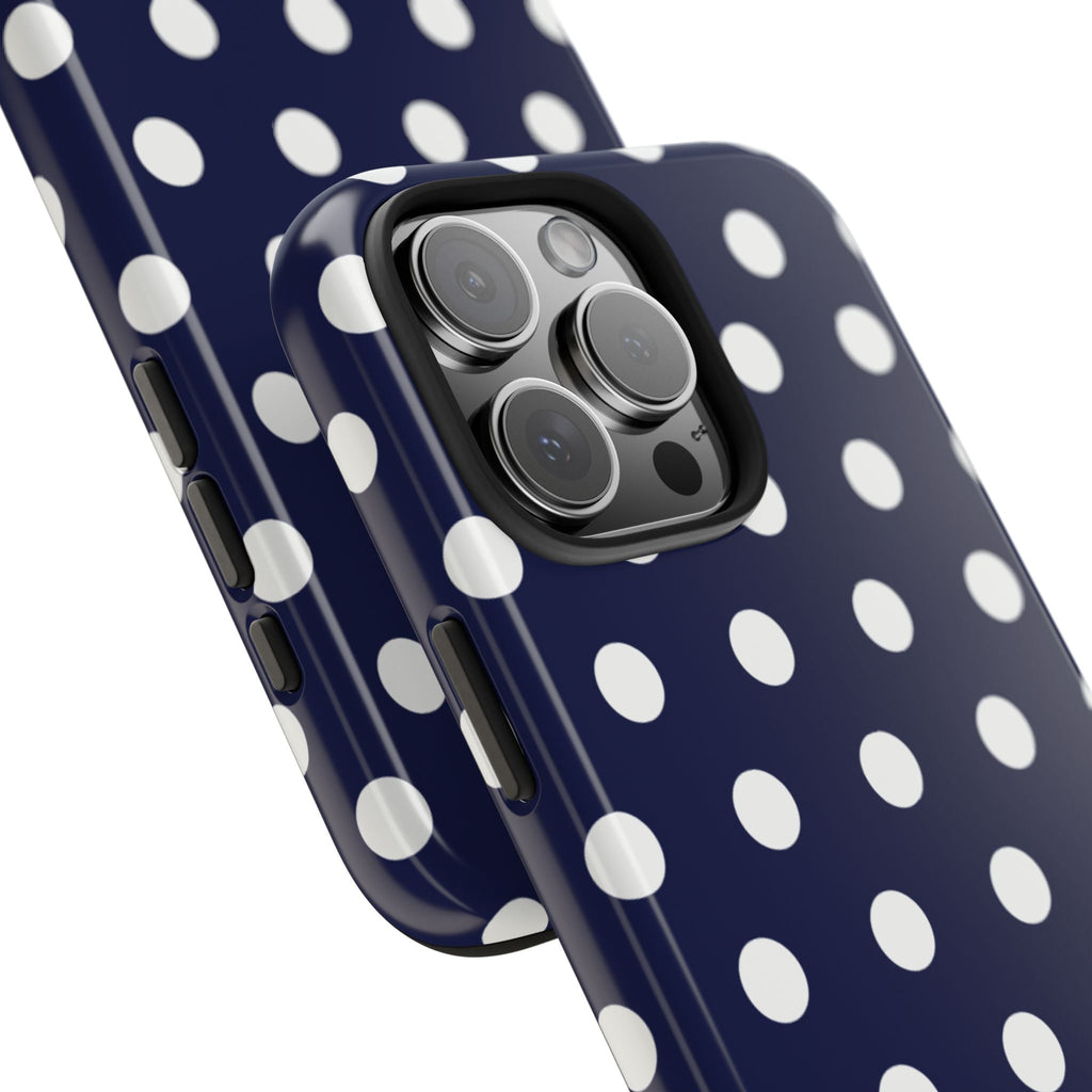 Navy polka dot phone case close-up showing camera bump and side buttons