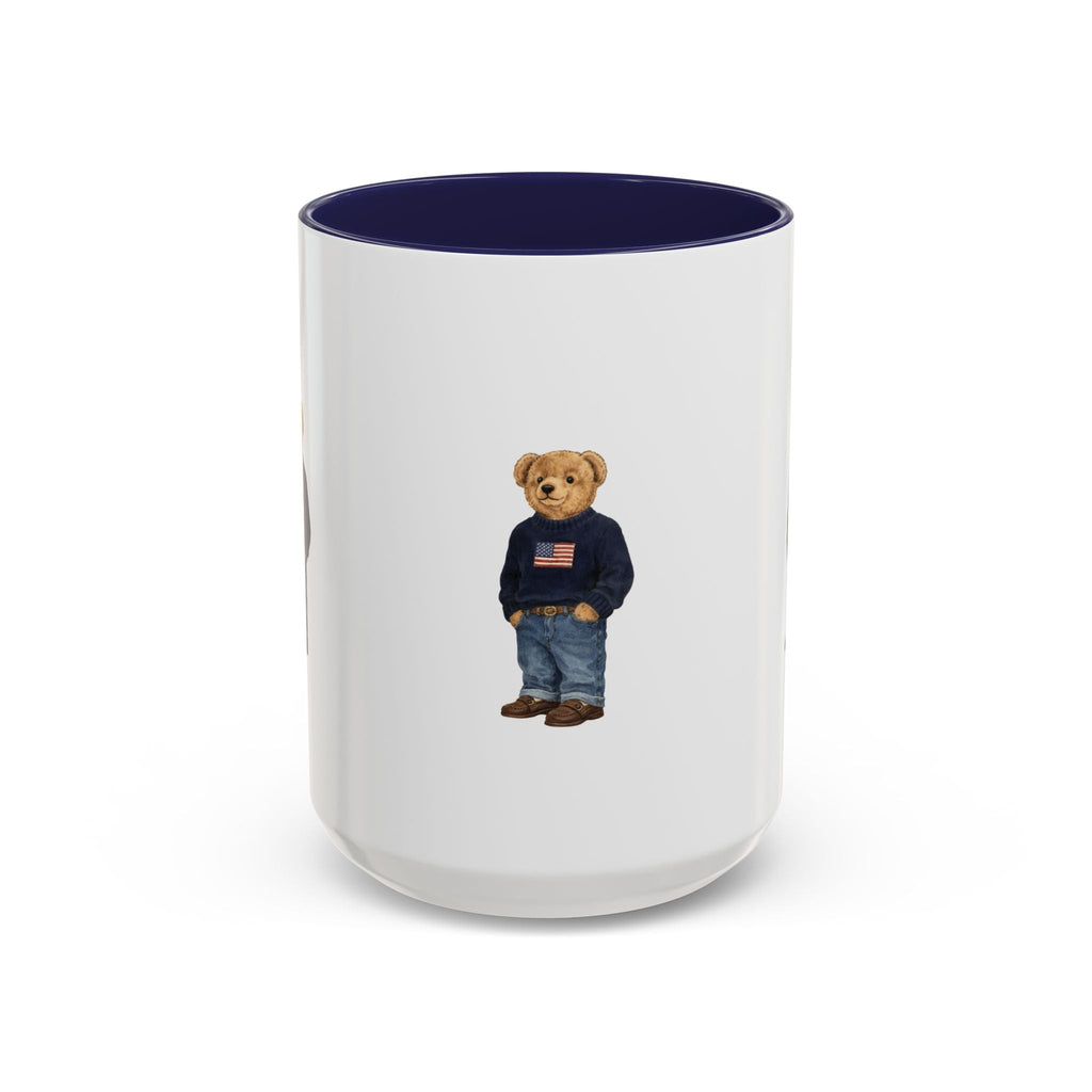 White ceramic mug with navy rim; teddy bear graphic wearing navy sweater and jeans