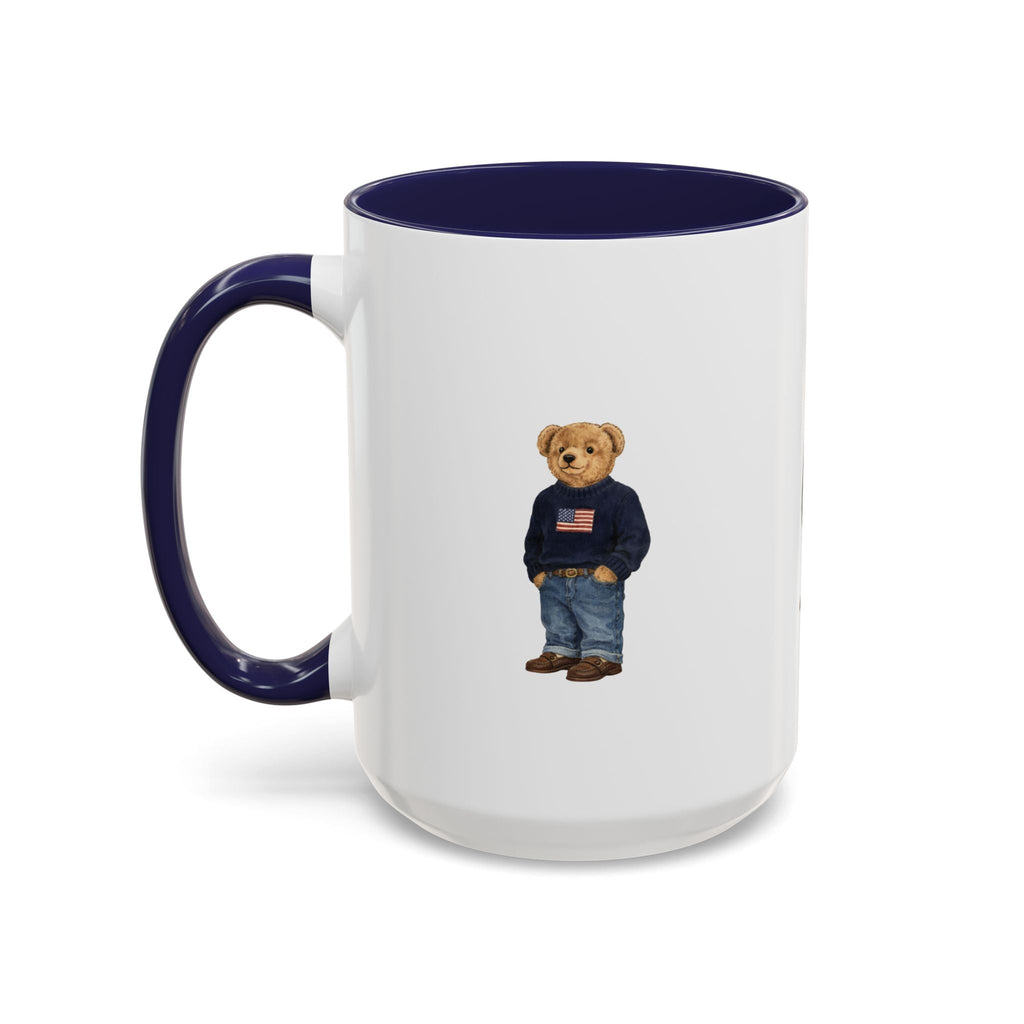 White ceramic mug with navy handle and rim; teddy bear graphic in navy sweater