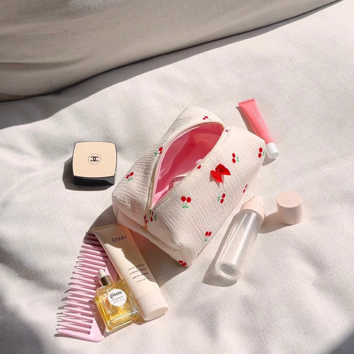 White zip pouch with cherry print, open top, and pink interior lining