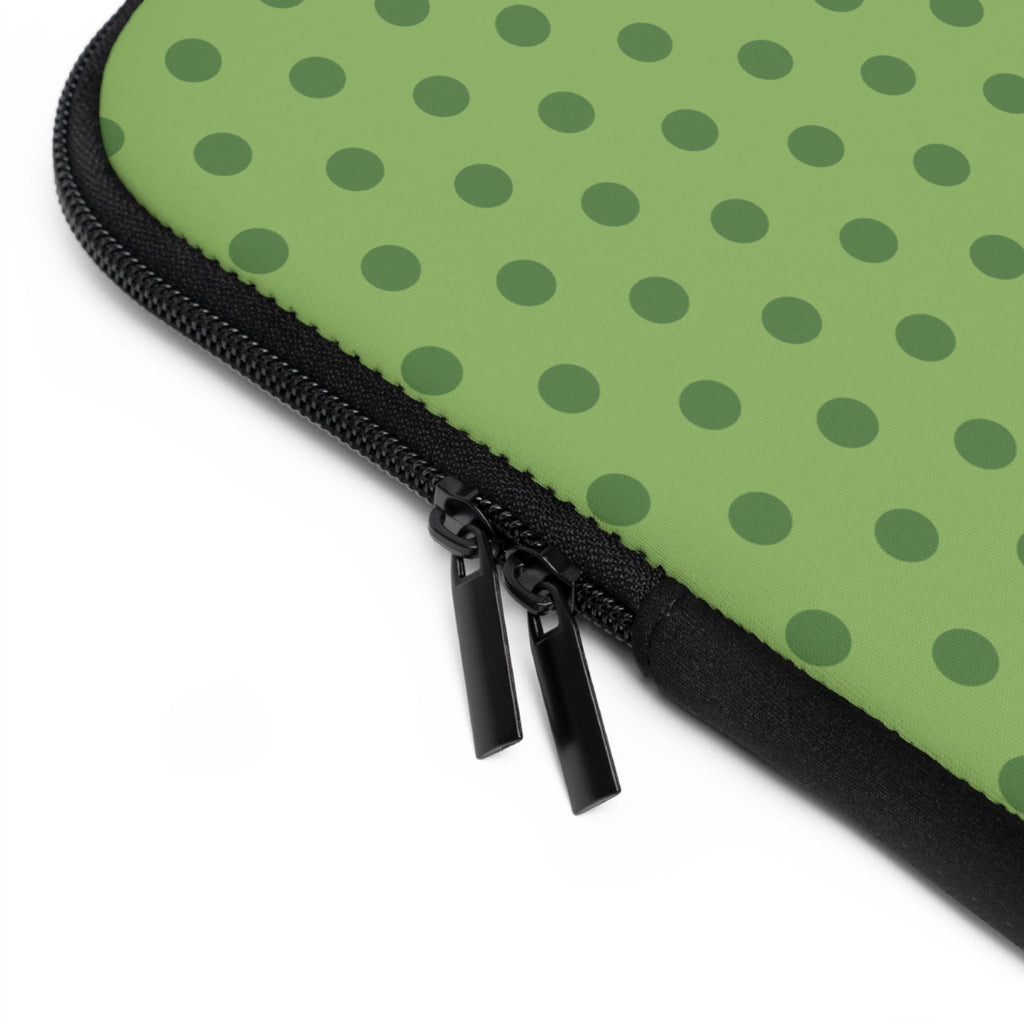Close-up: olive polka dot neoprene sleeve with black zipper pull