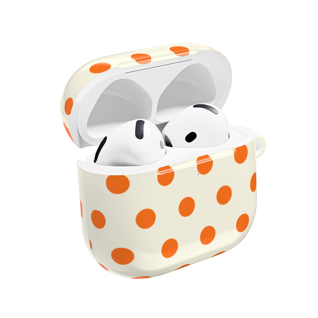 Cream AirPods case with orange polka dots, open with white earbuds inside