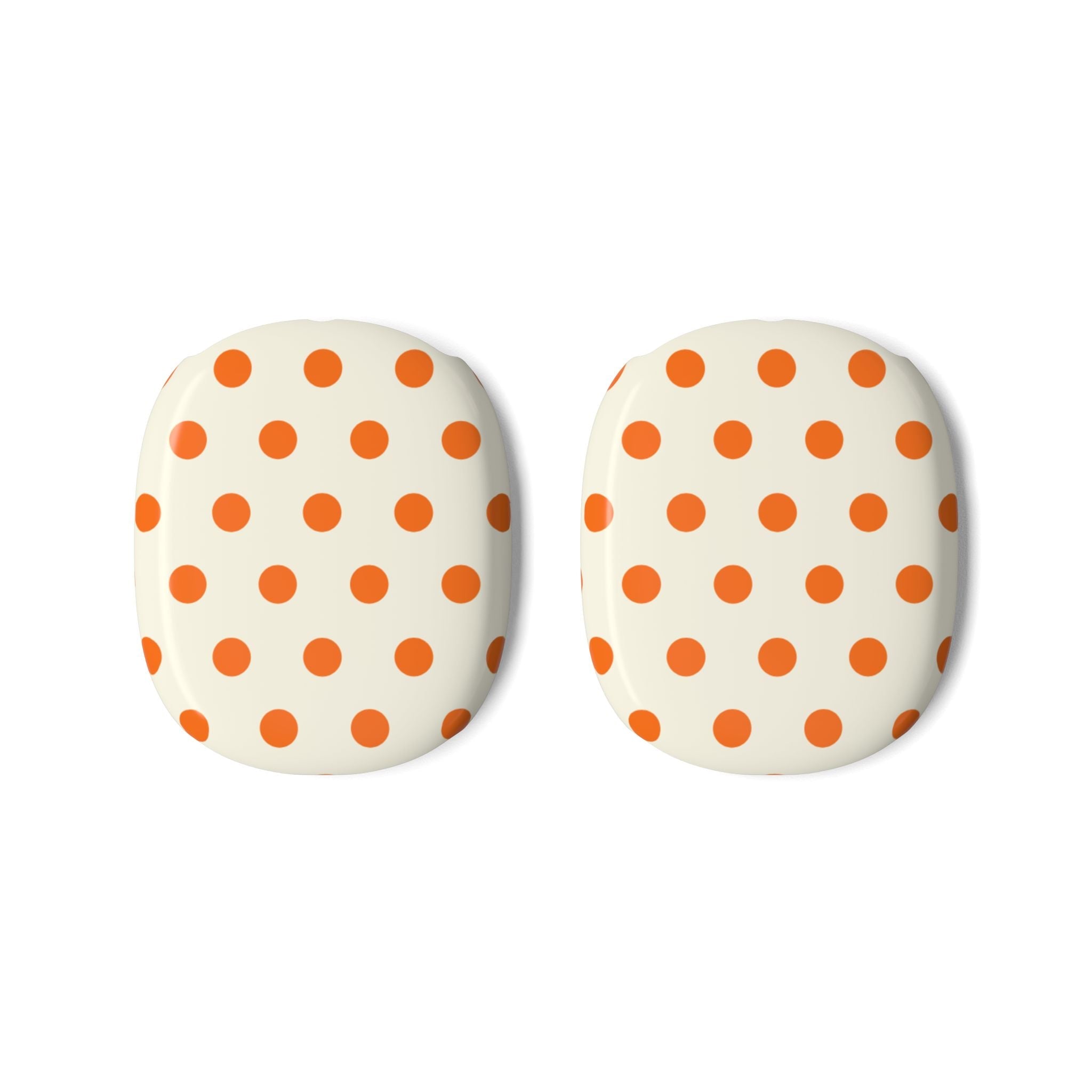 Two cream ear cup covers with orange polka dots for AirPods Max.