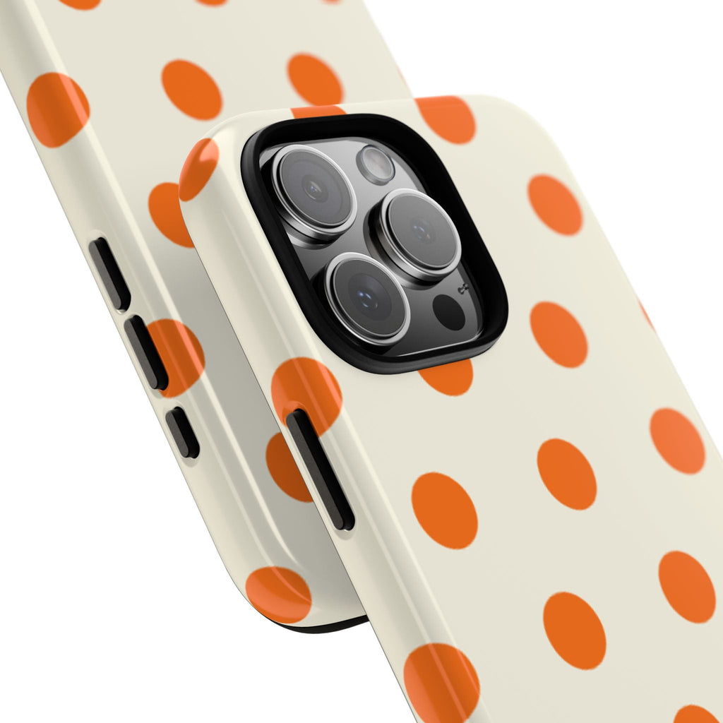 Cream polka-dot phone case with orange dots, side button cutouts near camera