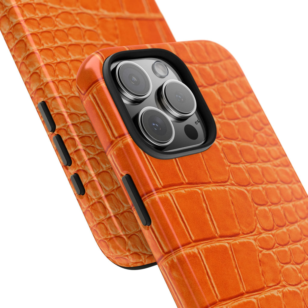 Orange croc-printed phone case showing lens bump and side button openings