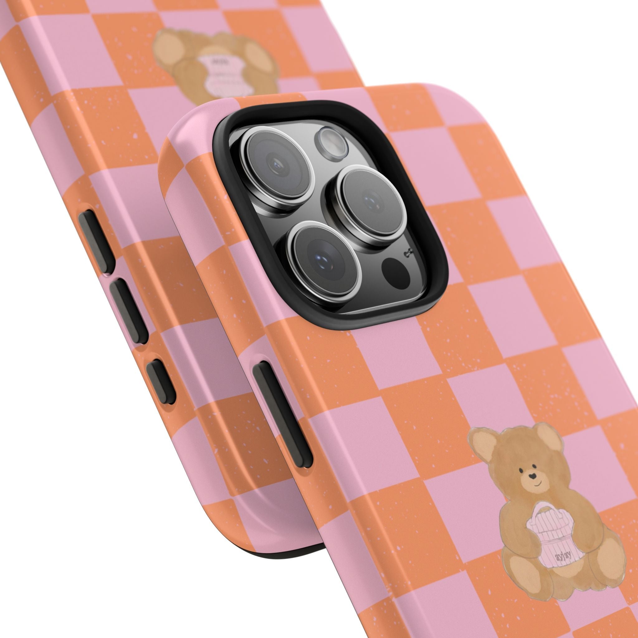 Angled view: orange and pink checkerboard teddy bear phone case with camera cutouts