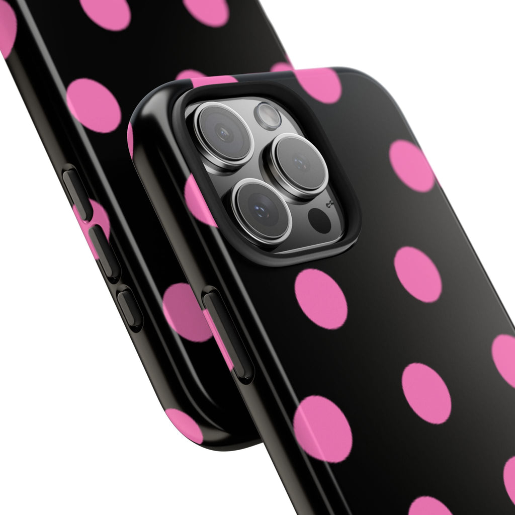 Phone case corner view with pink polka dots and camera cutout on black