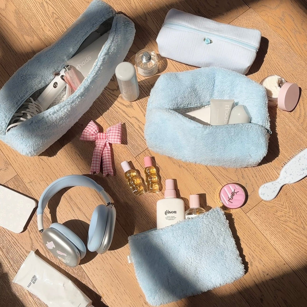 Light blue teddy plush zip pouch and matching soft case, neatly displayed on a table.
