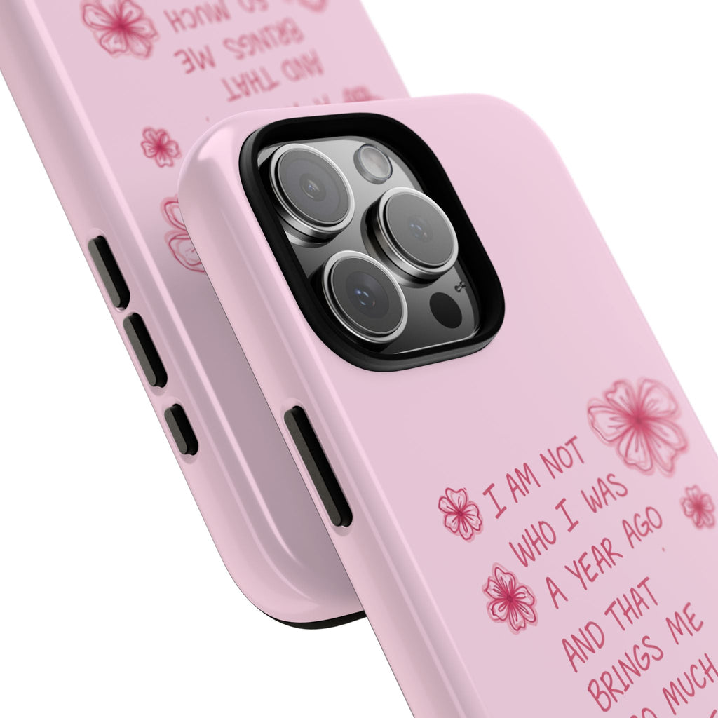 Angled pink phone case with floral quote, camera lens openings