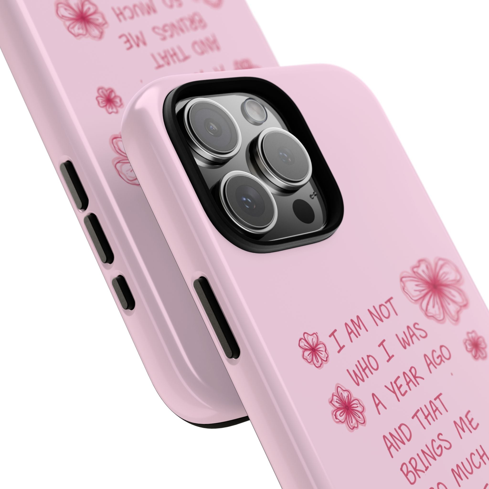 Angled pink phone case with floral quote, camera lens openings