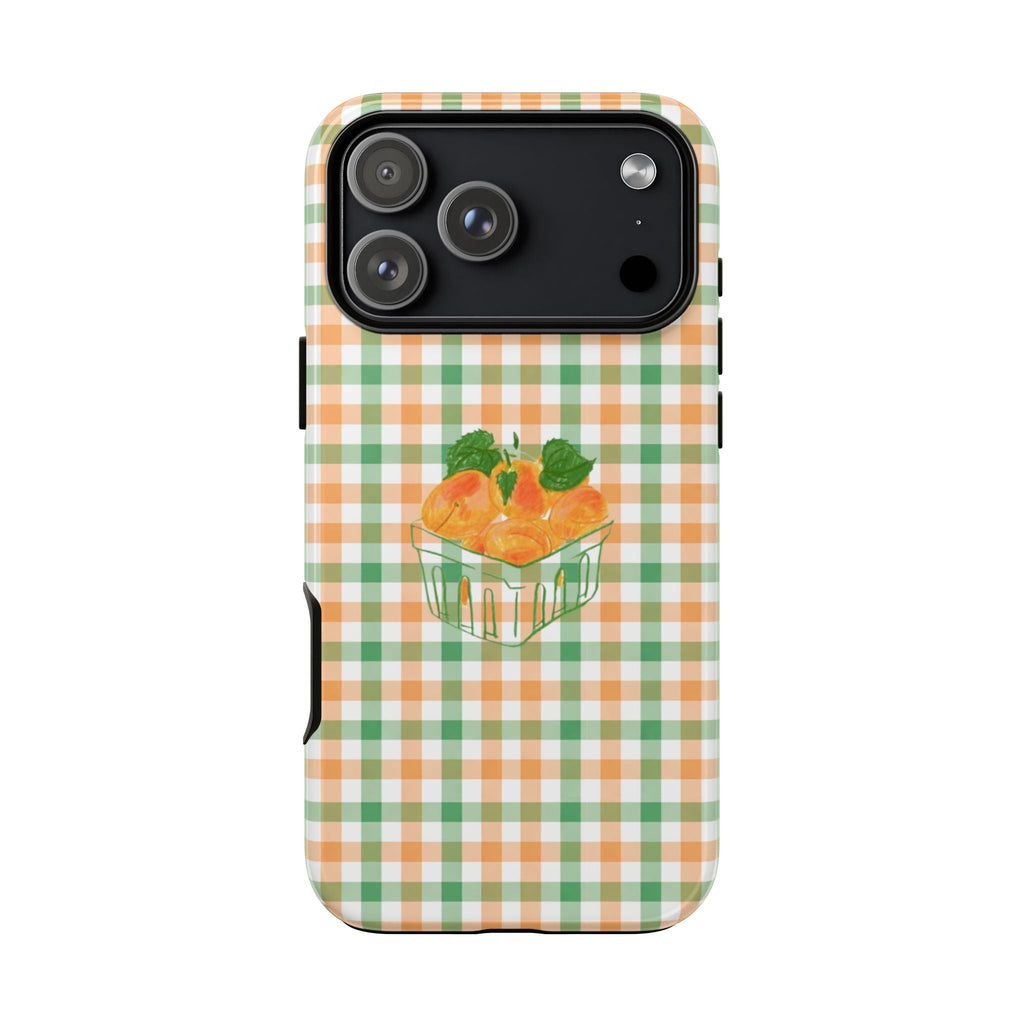 Phone case in orange and green gingham pattern with peach drink illustration over camera