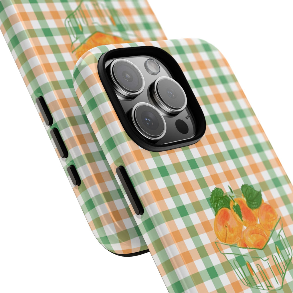 Side view of orange-and-green check phone case with peach cup design near camera lenses