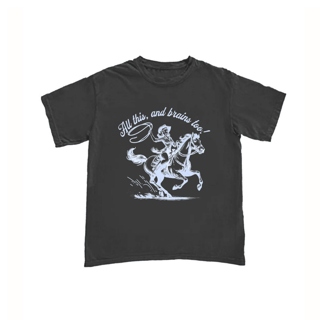 Dark T-shirt with cowboy riding horse graphic and “All this, and brains too” text