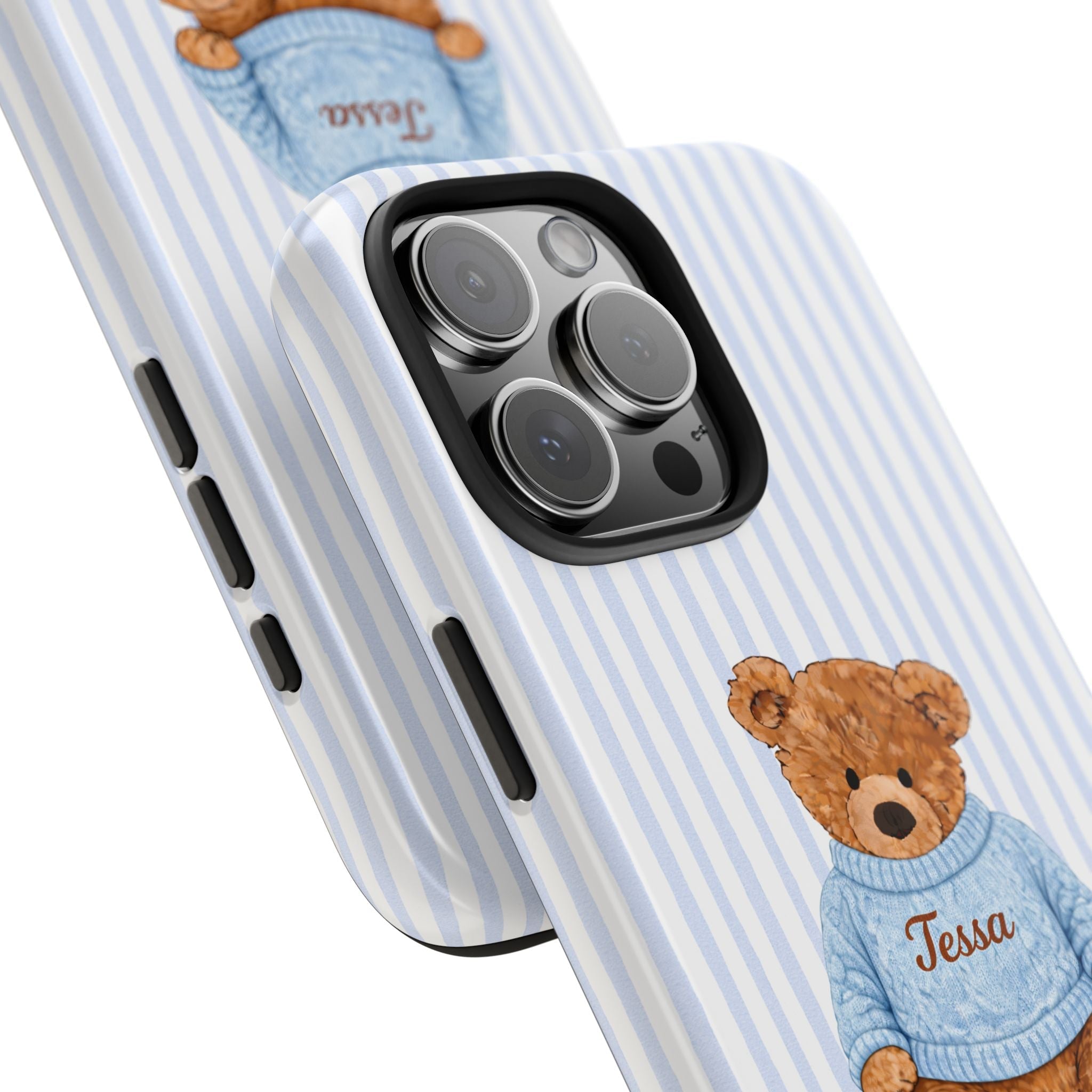 Diagonal view: blue striped phone case with teddy bear and blue sweater, name Tessa near camera