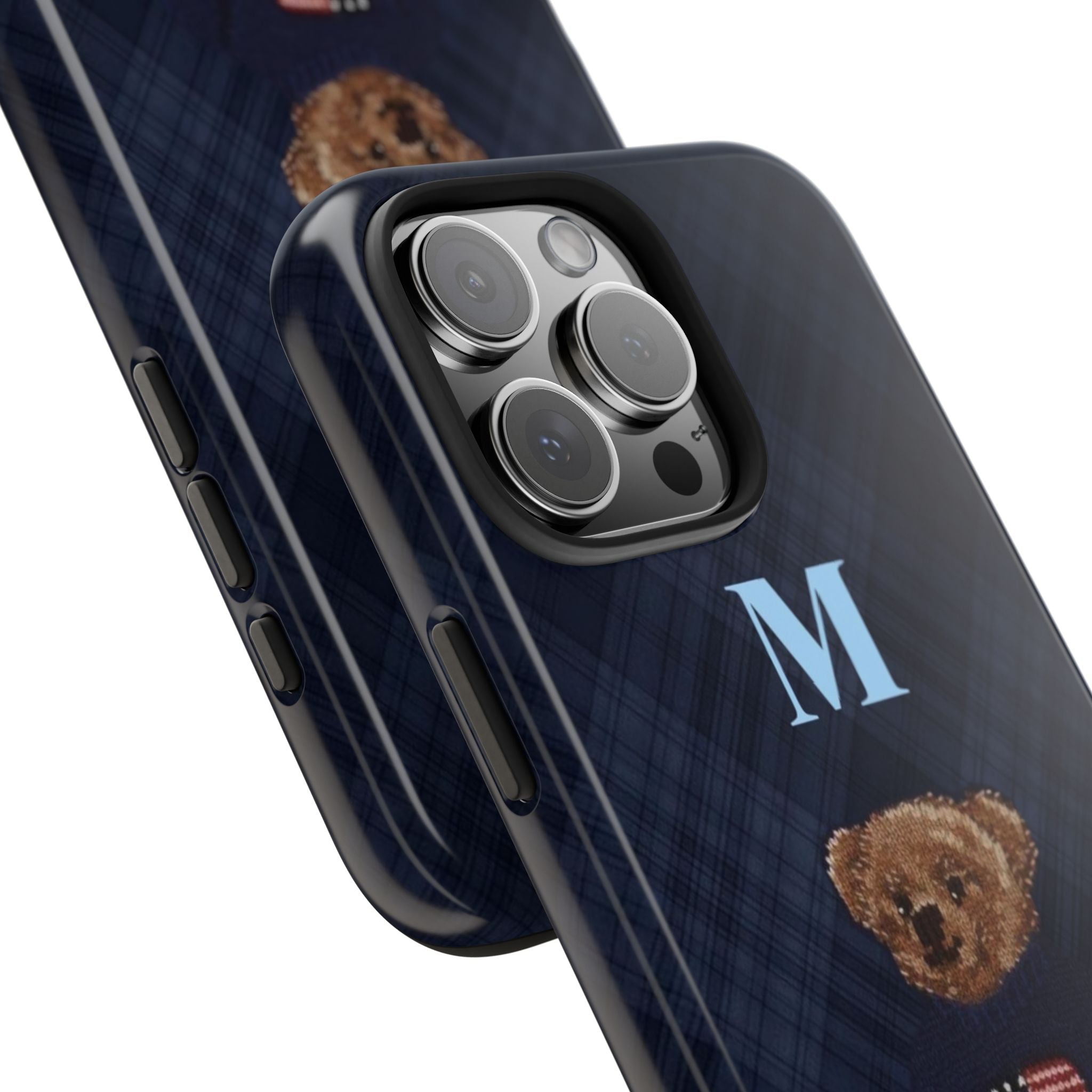 Navy plaid phone case close-up: cameras and side buttons, teddy bear patch and M
