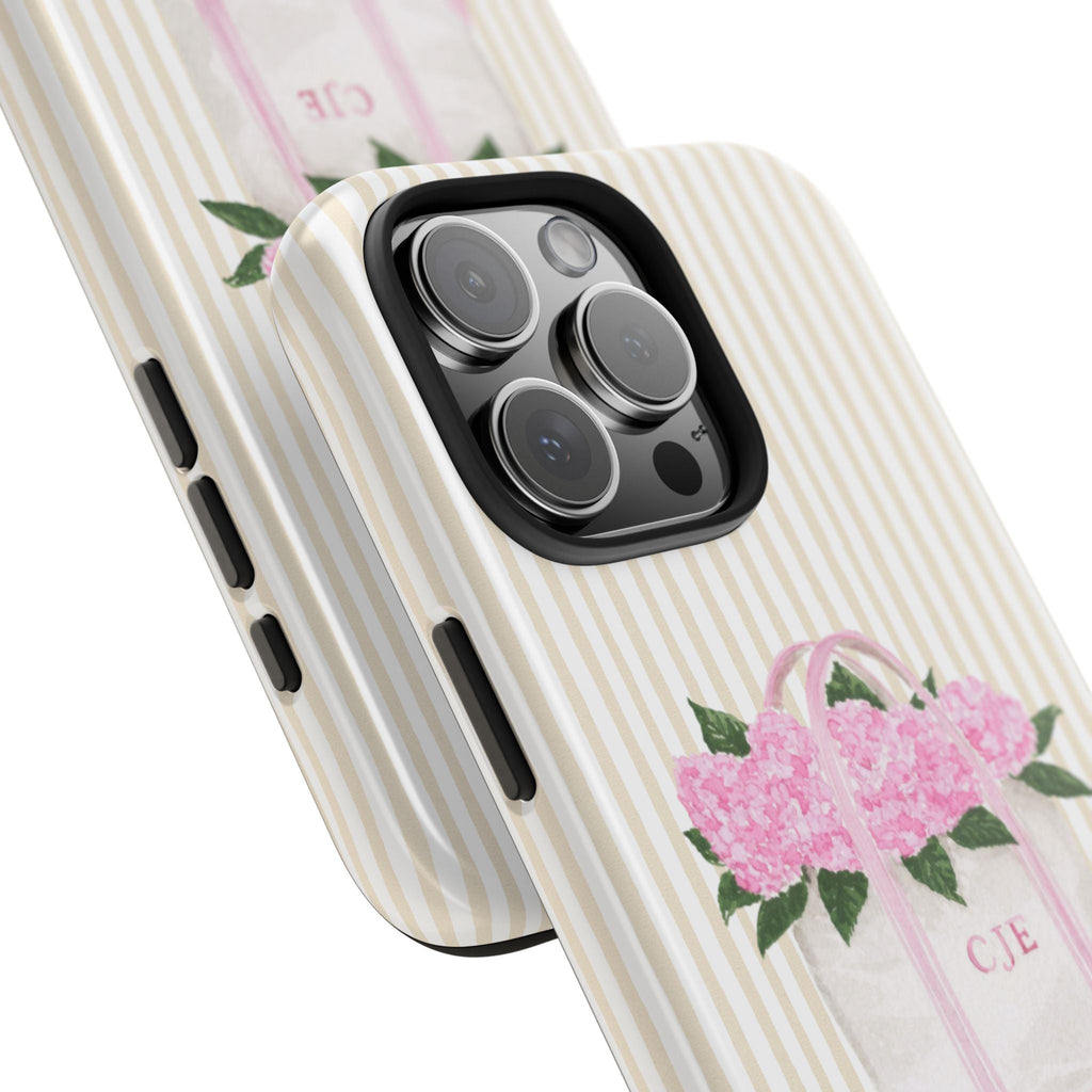 Angled cream striped phone case featuring a pink flower bag graphic with initials CJE