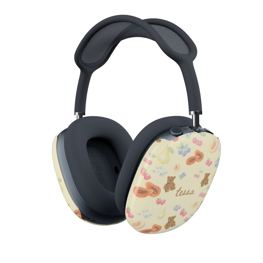 AirPods Max case cover on dark headphones; cream pattern with bears and cursive name “tessa”