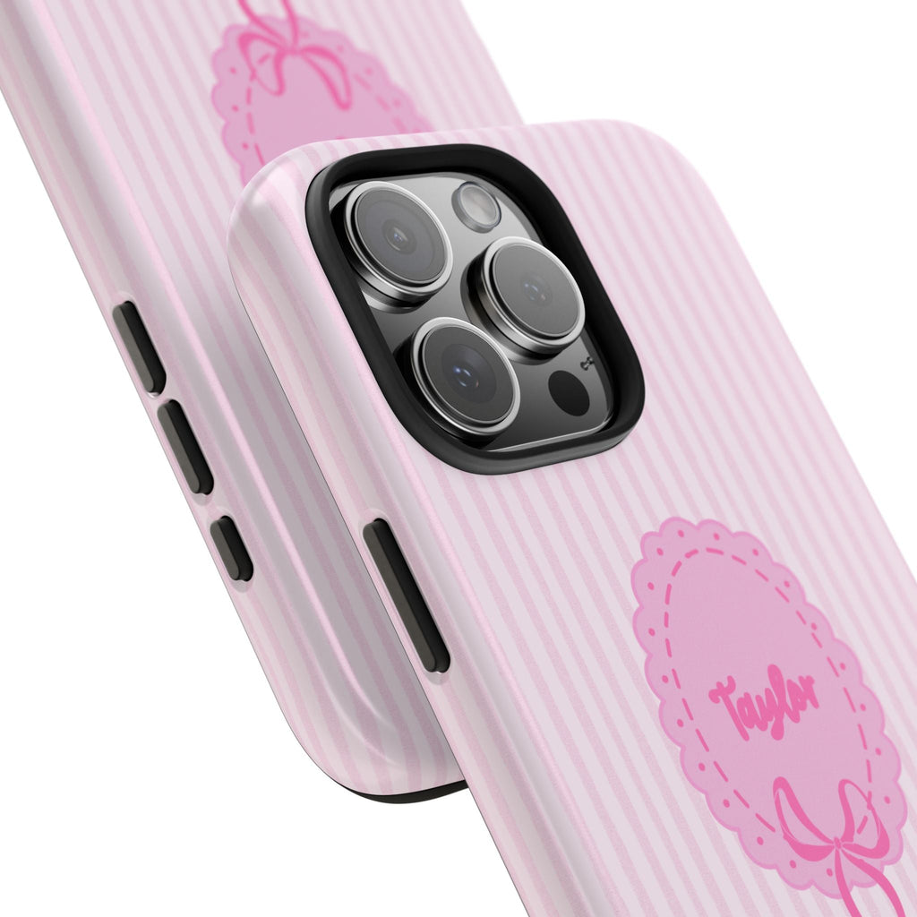 Pink striped case detail: Taylor name badge, bow motif, side buttons and camera