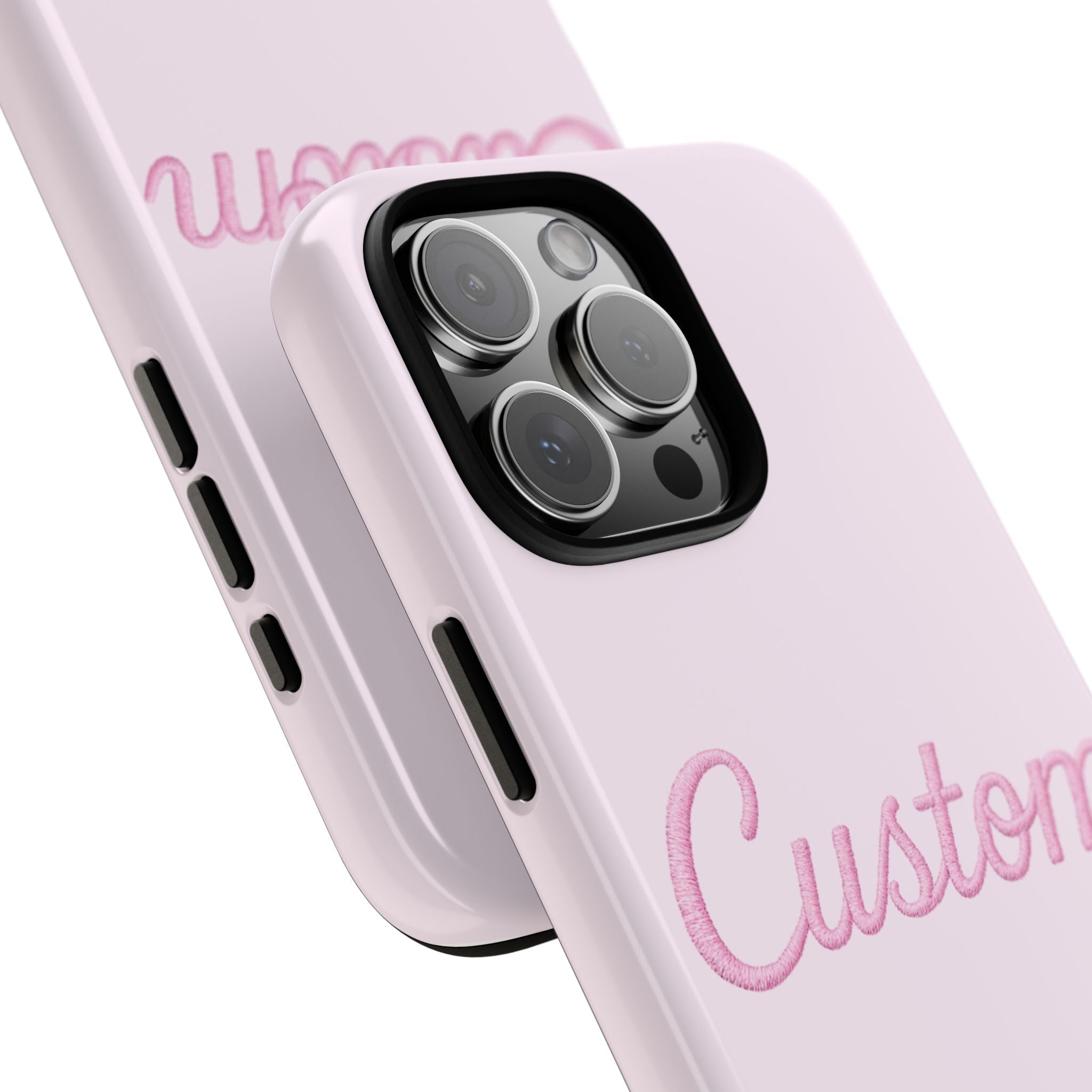 Close-up pink custom phone case with camera lenses and “Custom” script