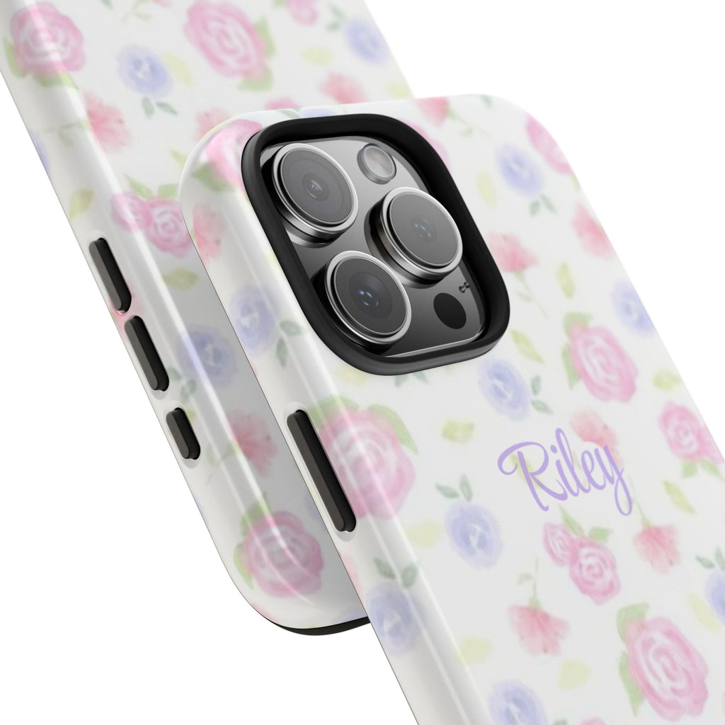Angled view of personalized pink floral phone case with “Riley,” camera cutout and buttons