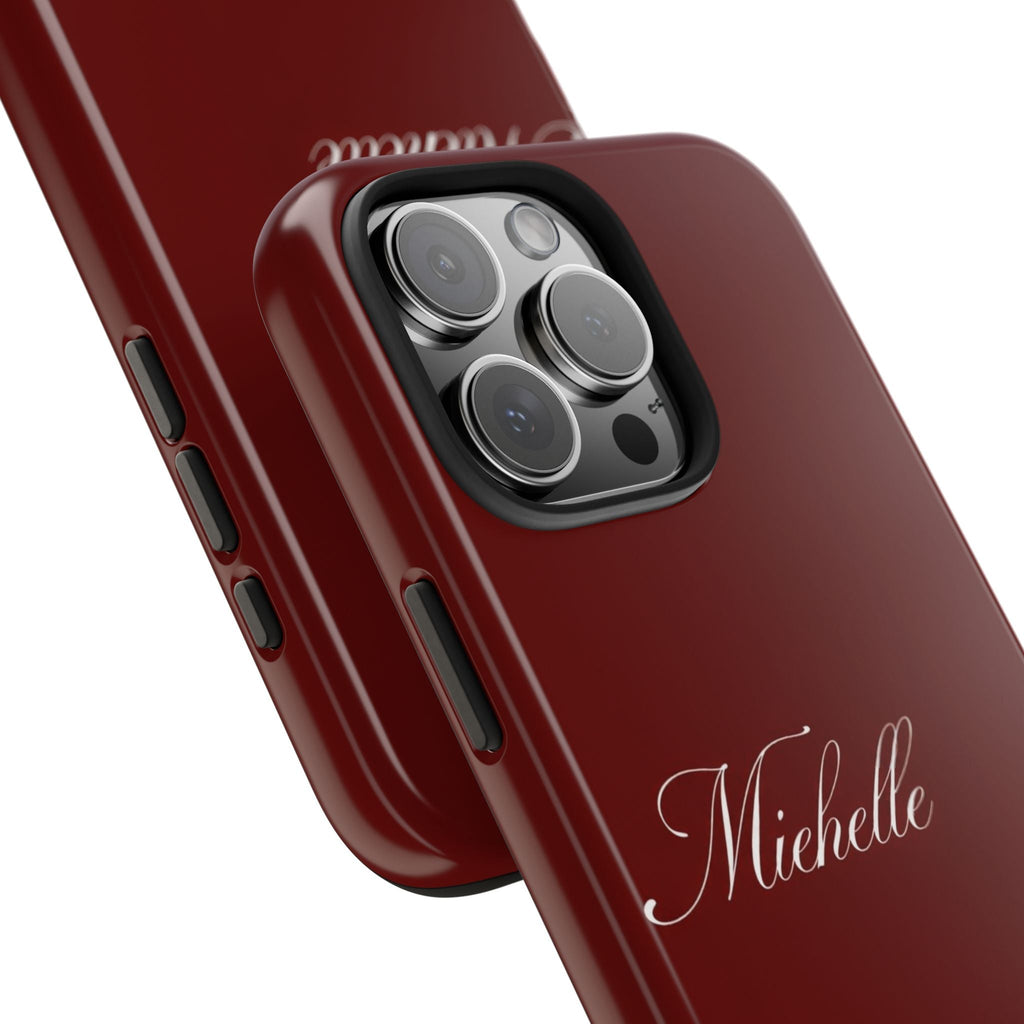 Close-up of red personalized phone case showing “MicheIle” name and camera lenses