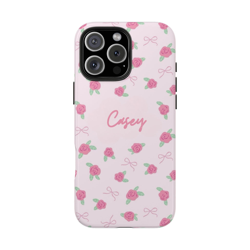 Personalized phone case with pink rosebud pattern and 'Casey' name, light pink background